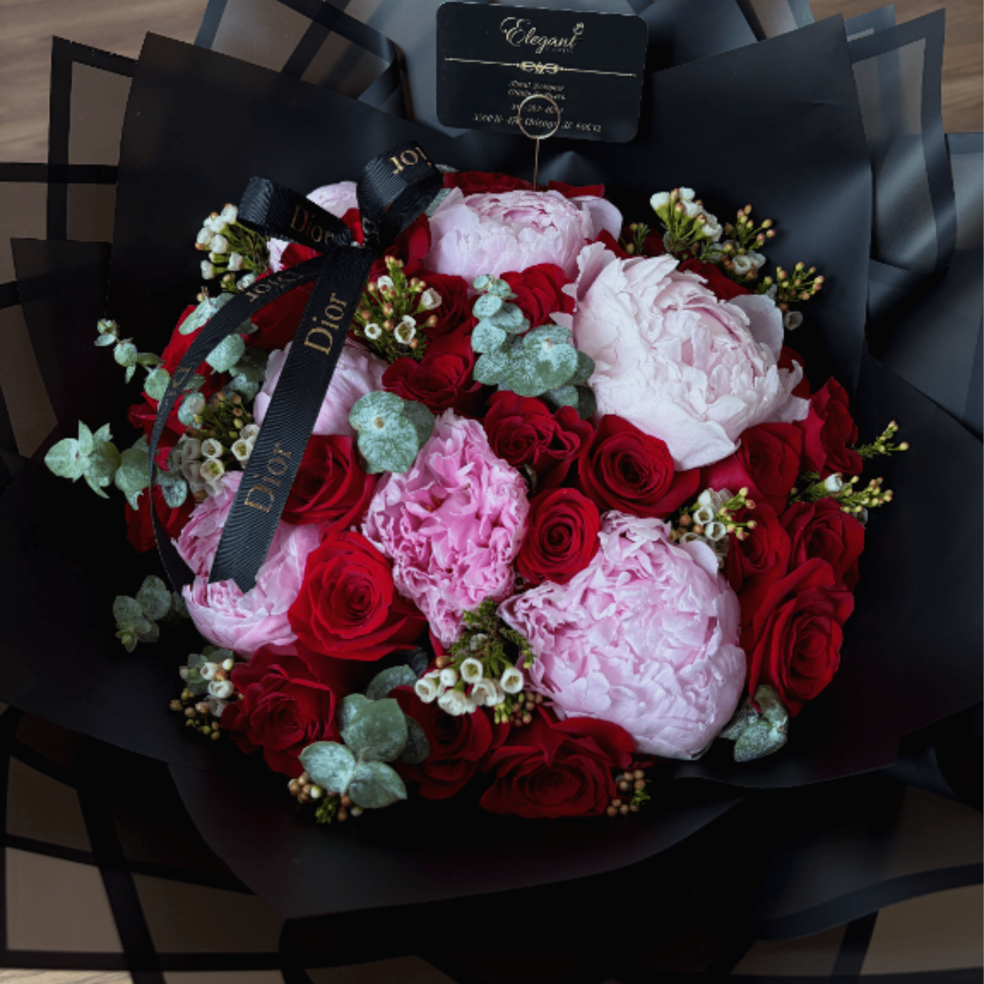 This luxurious arrangement features 24 premium long-stem red roses (70 cm), carefully