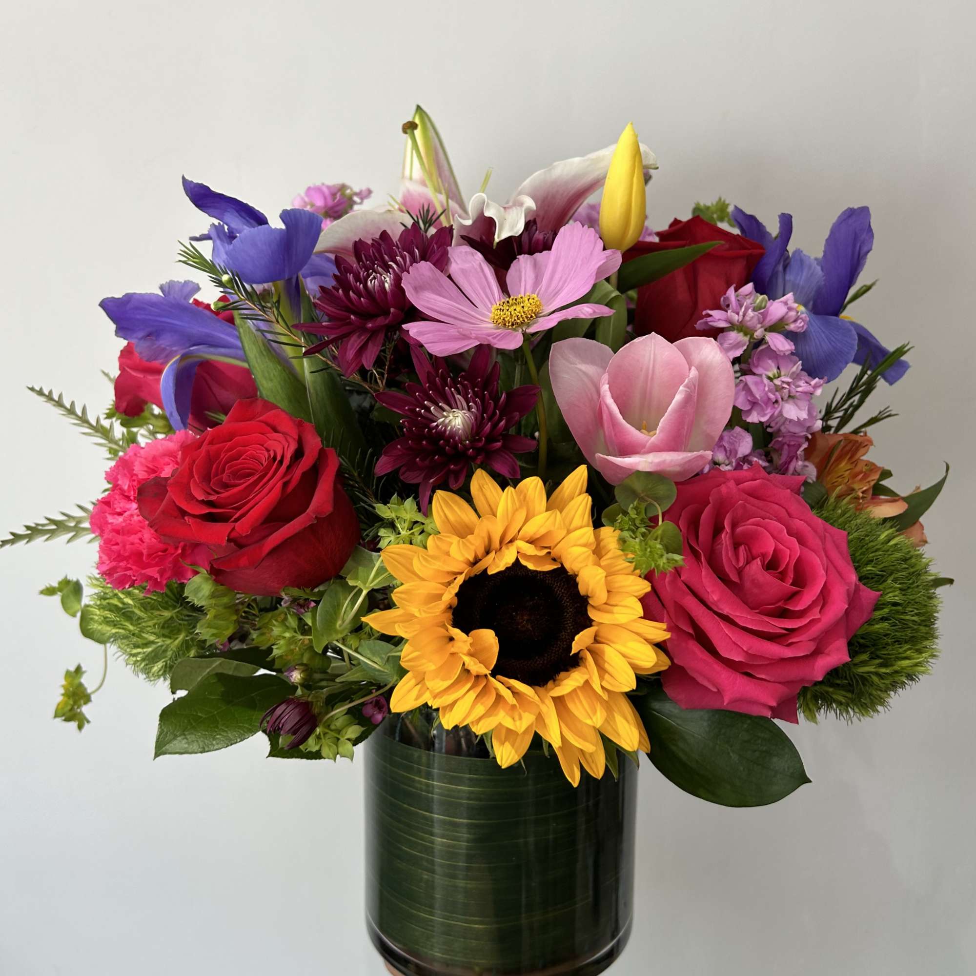 Seasonal bright flowers arranged in a vase. 