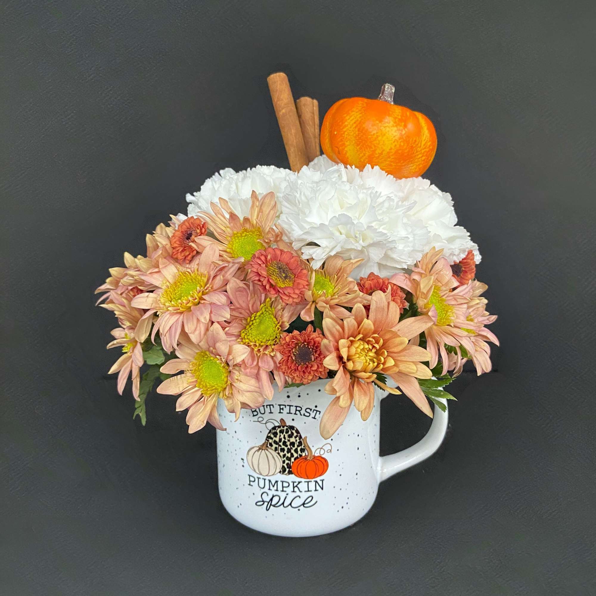 Mug arrangement of peach and white chrysanthemums with a pumpkin topper