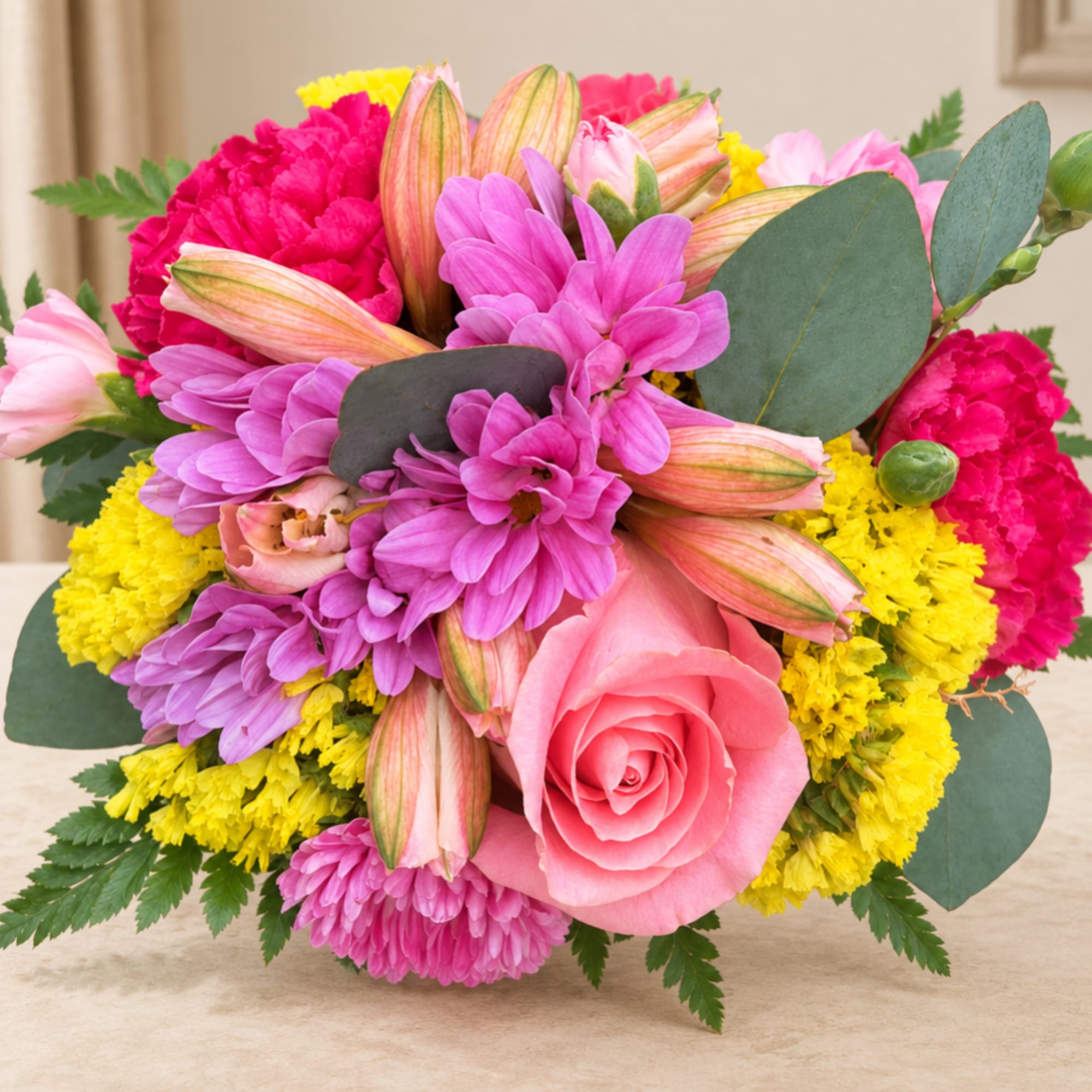 Pink and purple bouquet with a rose in the center