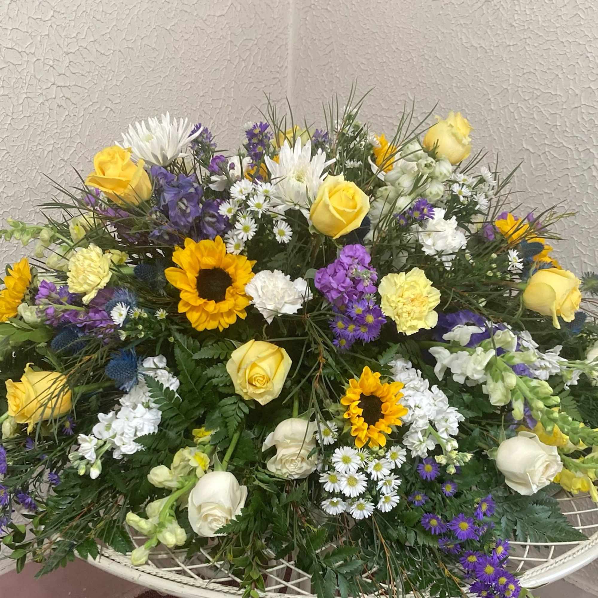Mixed bouquet with yellow roses, sunflowers, and white blooms
