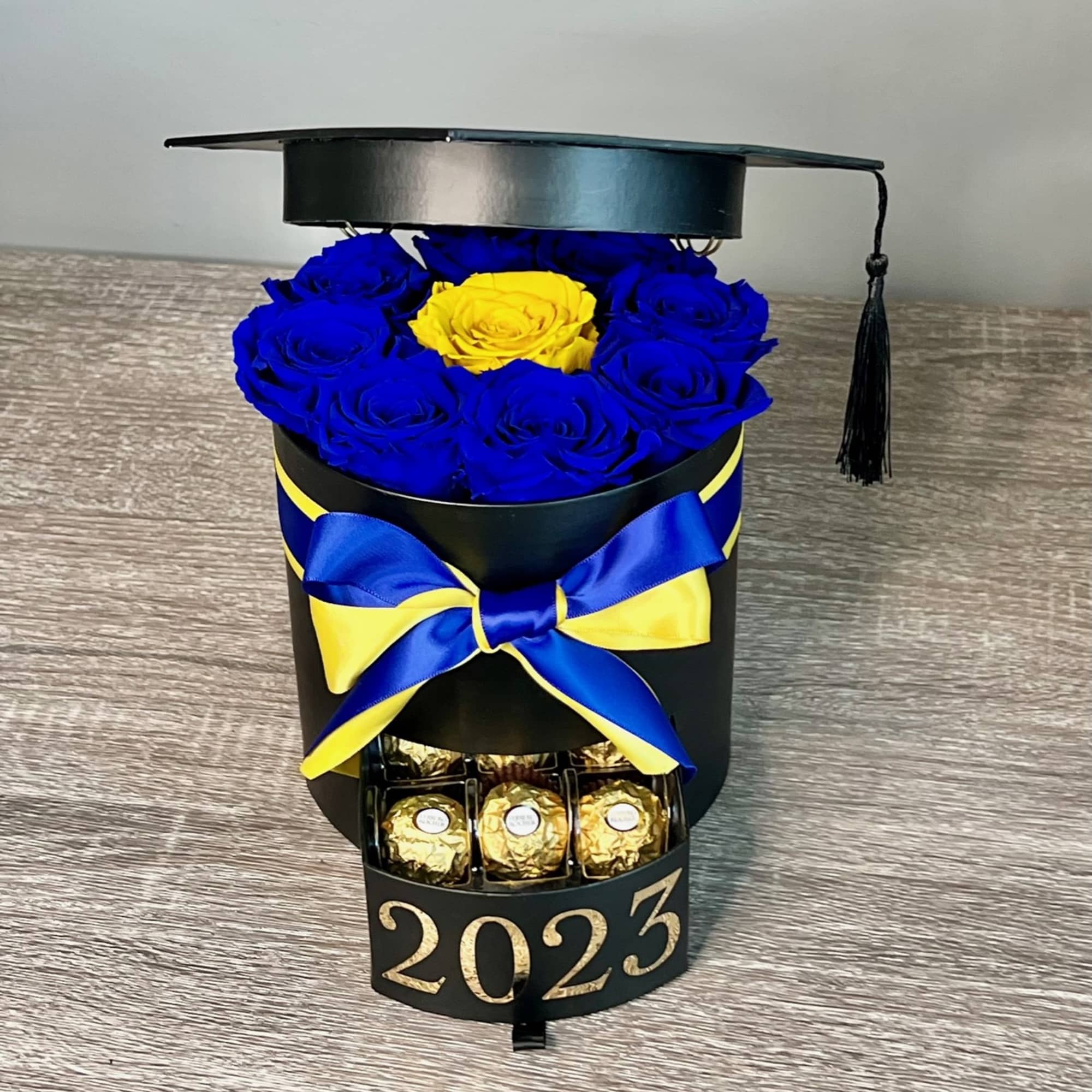 Graduation cap box with blue and yellow roses and chocolates