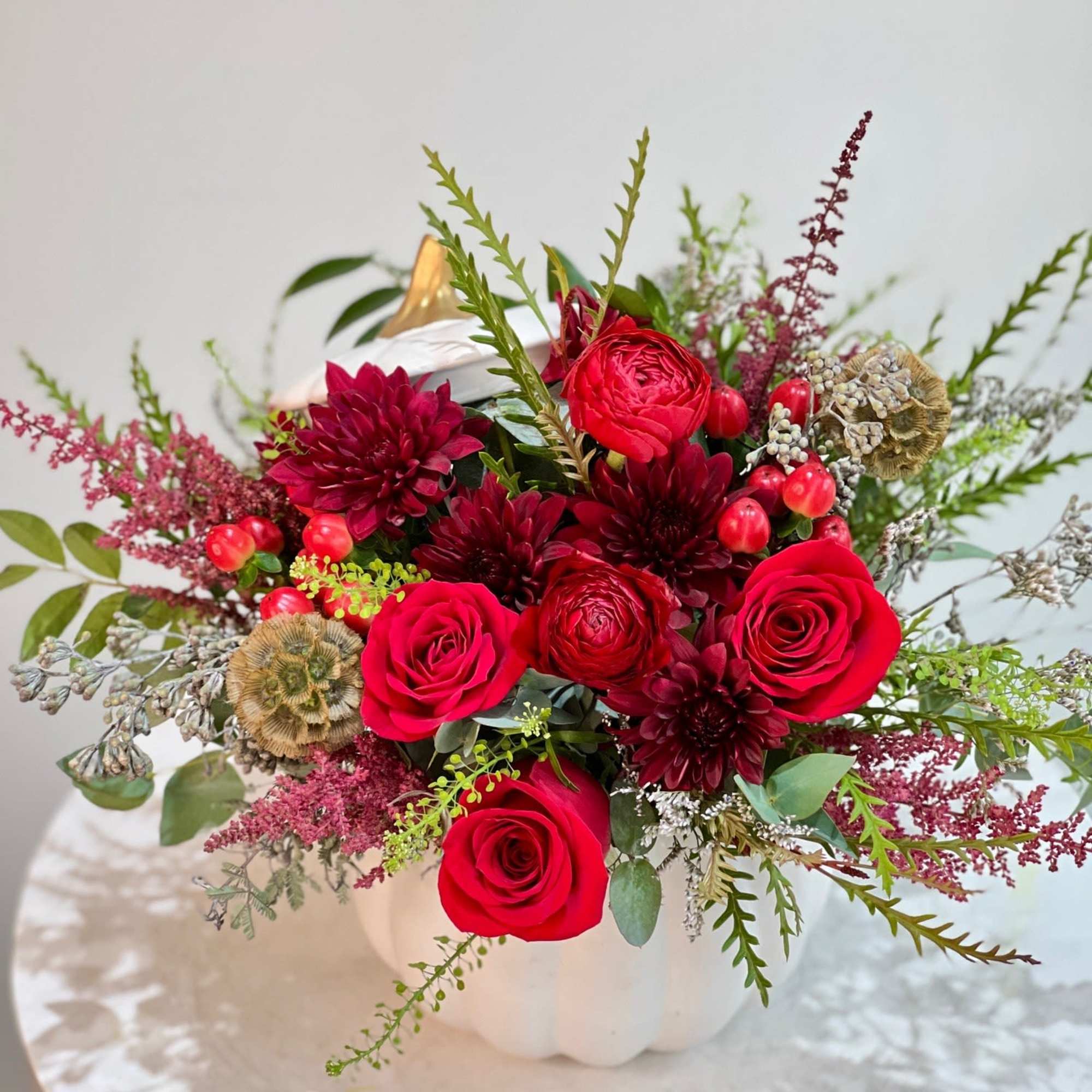 This bold autumn-inspired arrangement bursts with romance and warmth. Deep red roses, photo 2 of 2