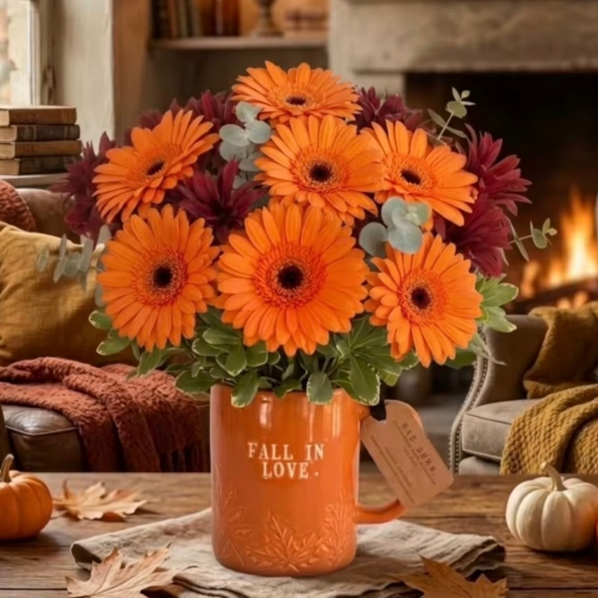 Orange gerbera daisies in an orange mug on a fall table