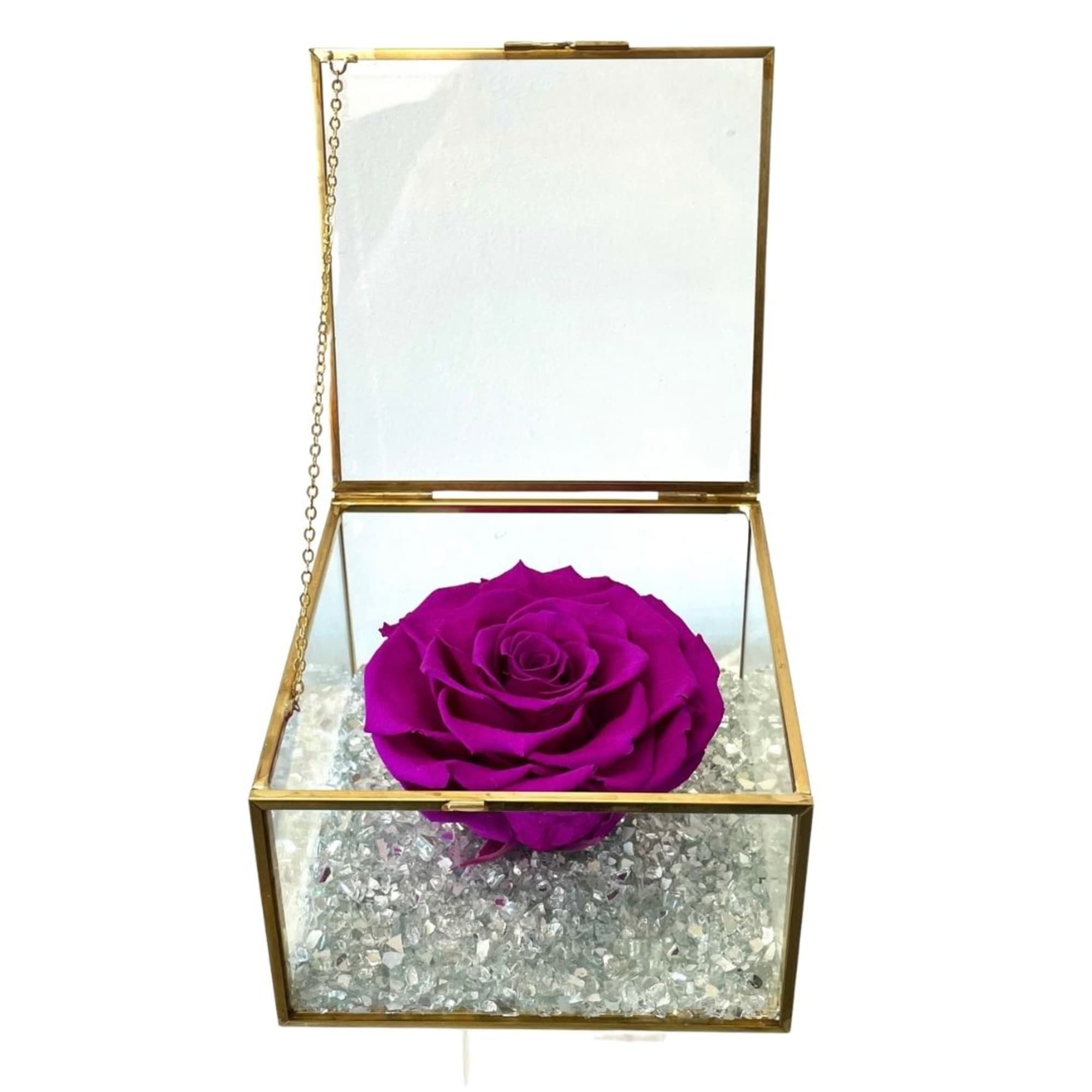 Single purple rose in a gold glass box with crystal filler