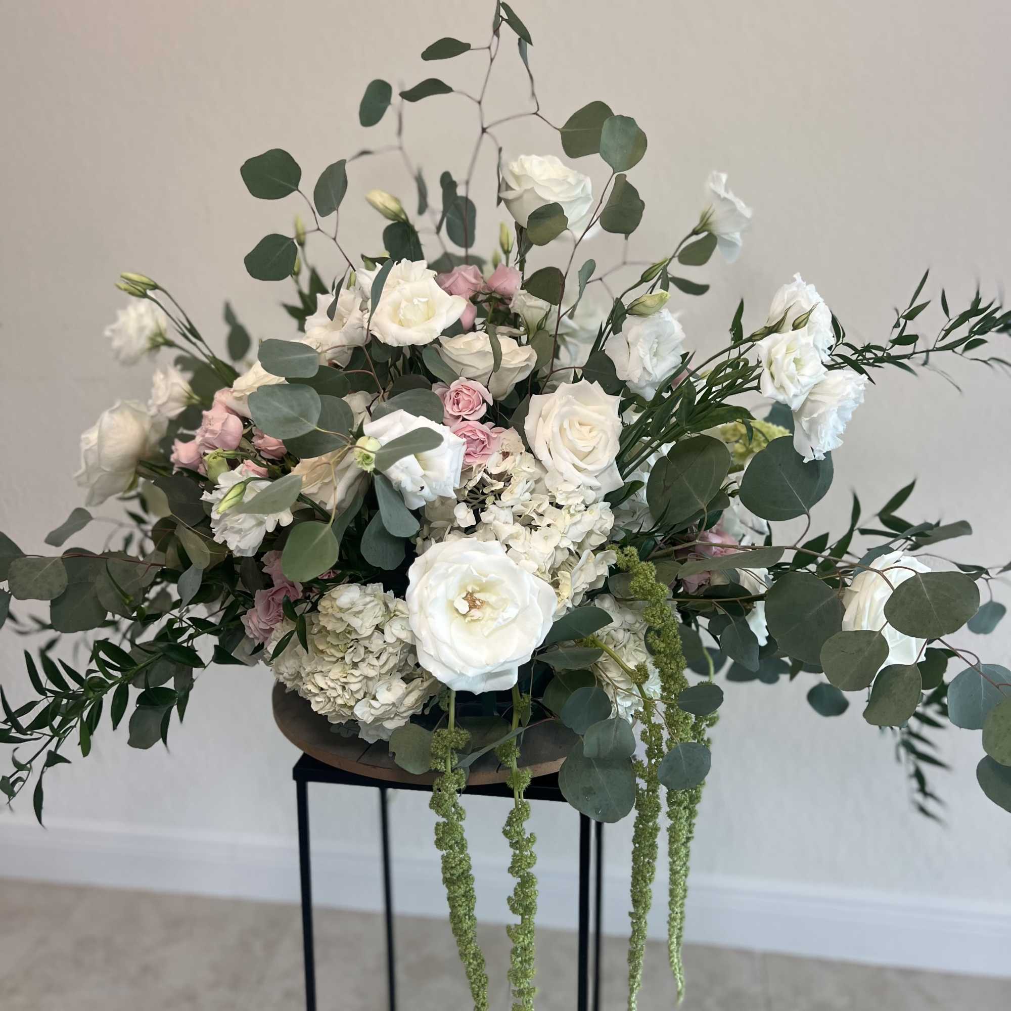 White and blush floral arrangement with eucalyptus in a low vase