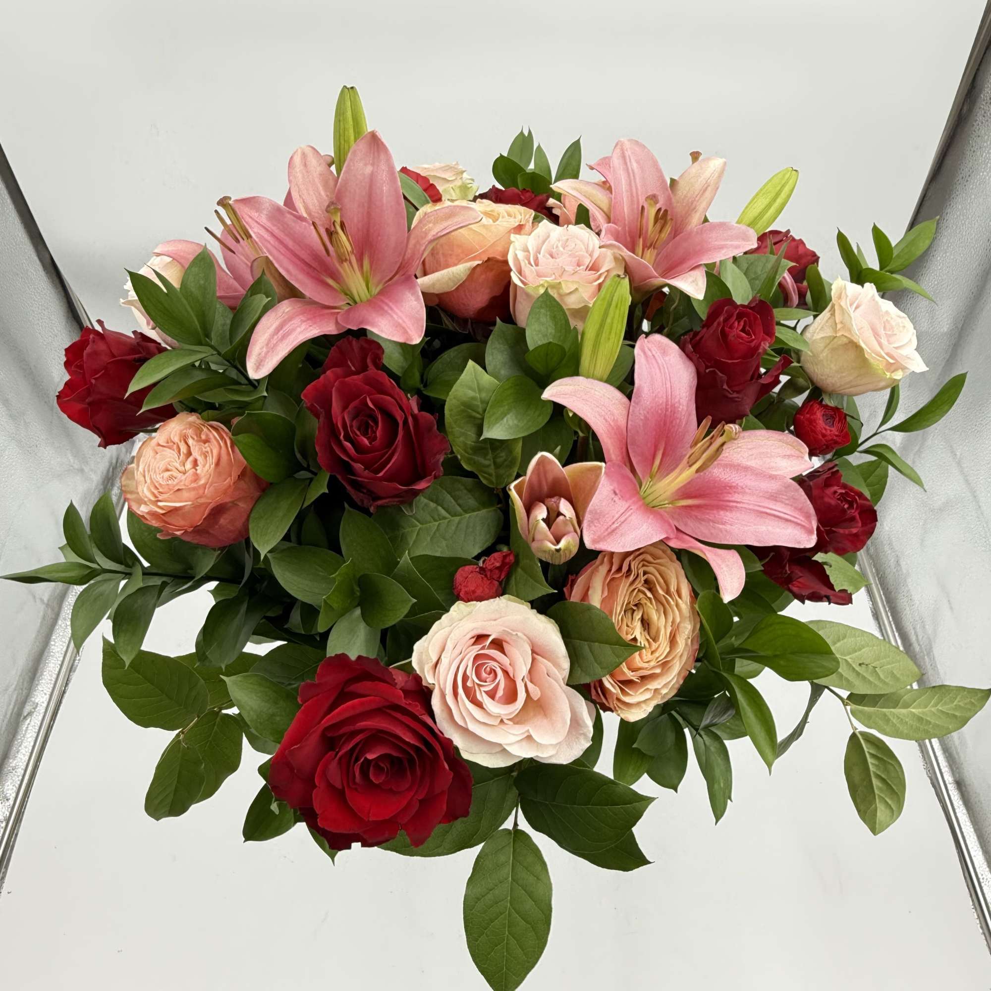 Bouquet of pink lilies and red and blush roses