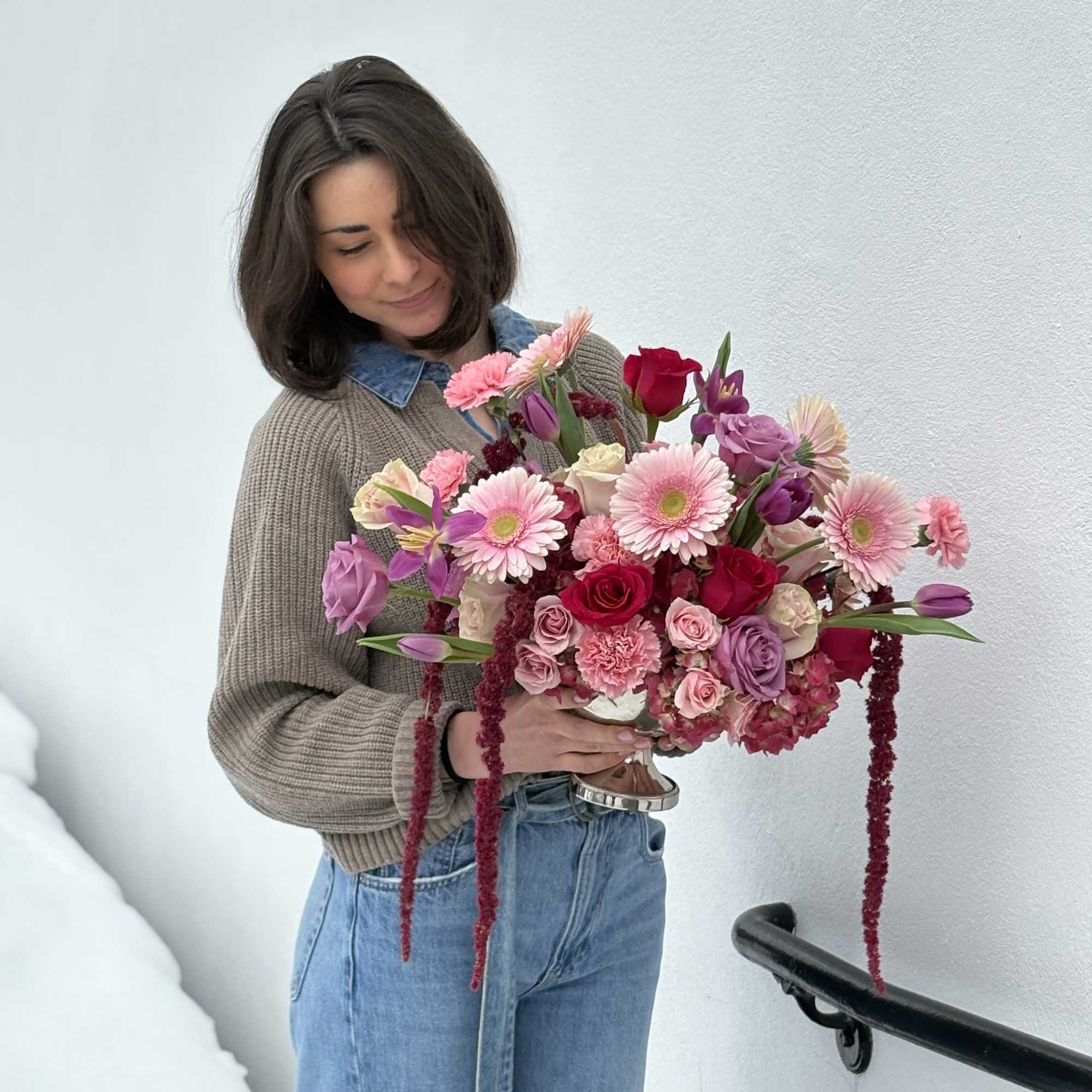 Woman holding a large pink and purple bouquet