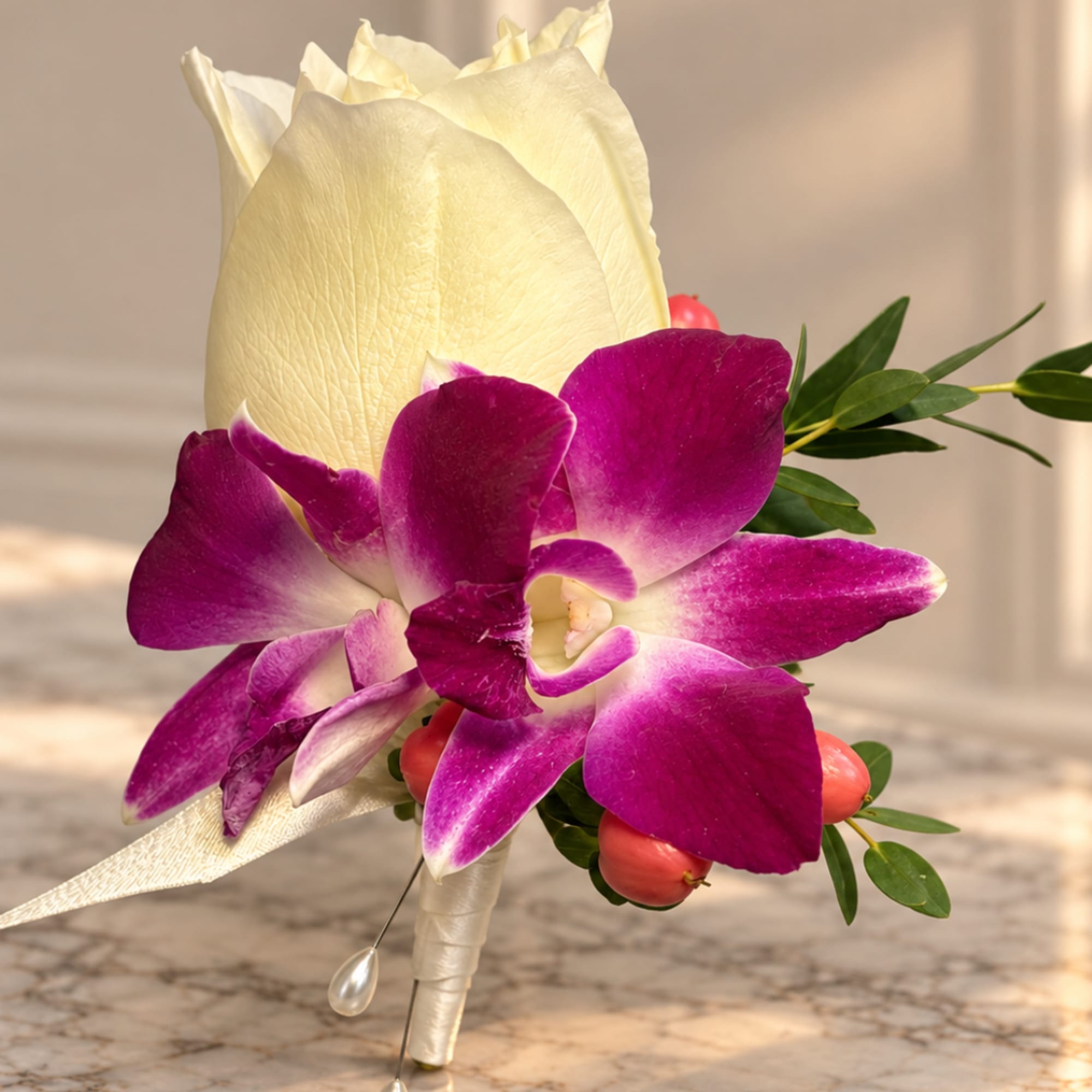 White rose and purple orchid boutonniere with small berries