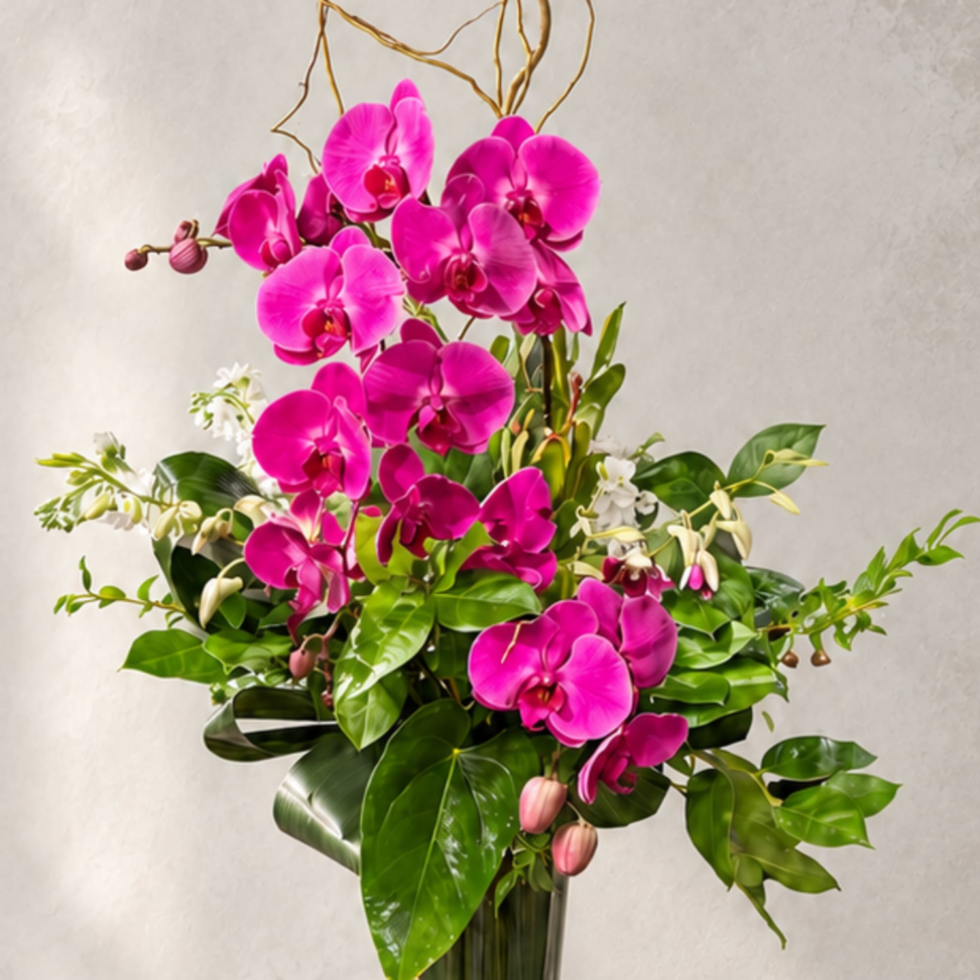 Bright pink orchids arranged in a tall vase with glossy green leaves