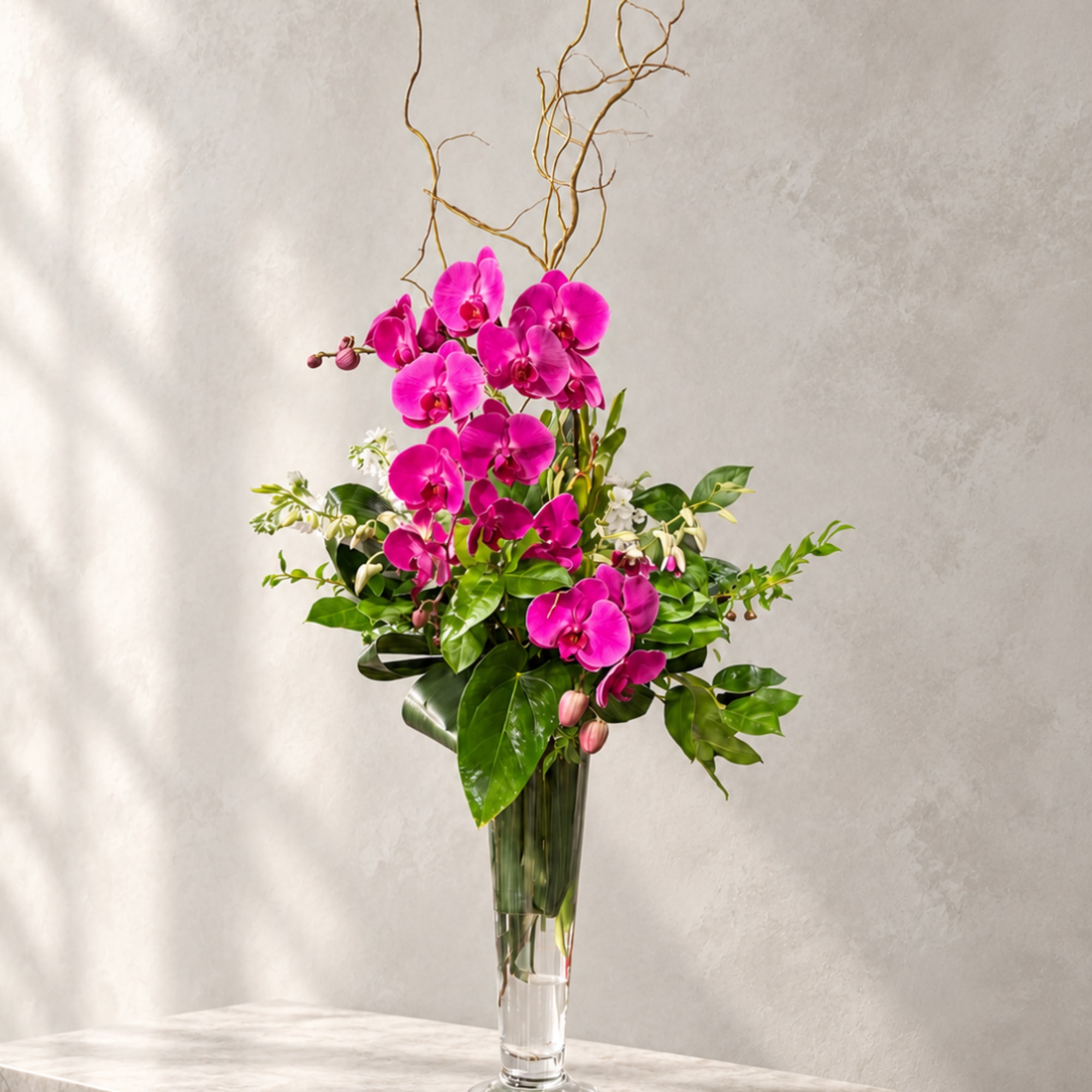 Tall arrangement of bright pink orchids in a clear glass vase, photo 3 of 3