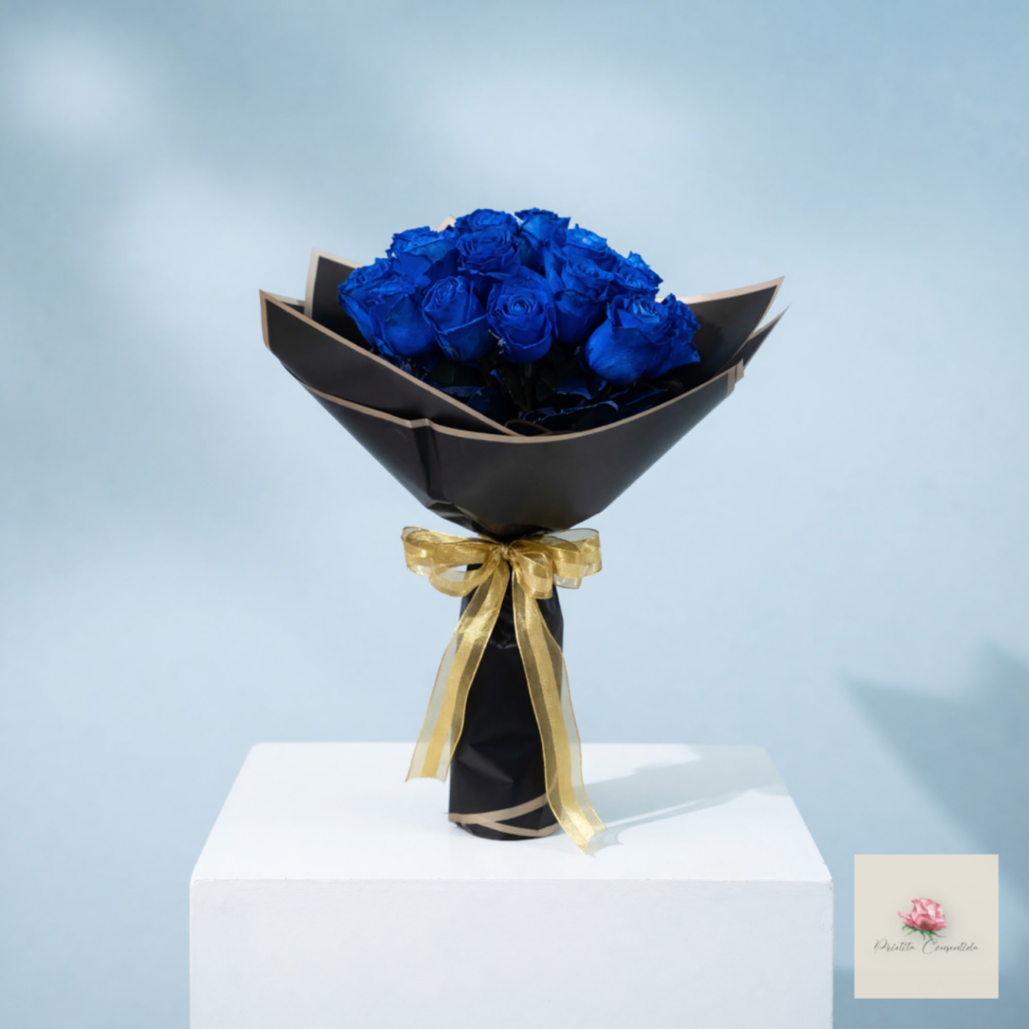 Bouquet of blue roses wrapped in black paper with a gold ribbon