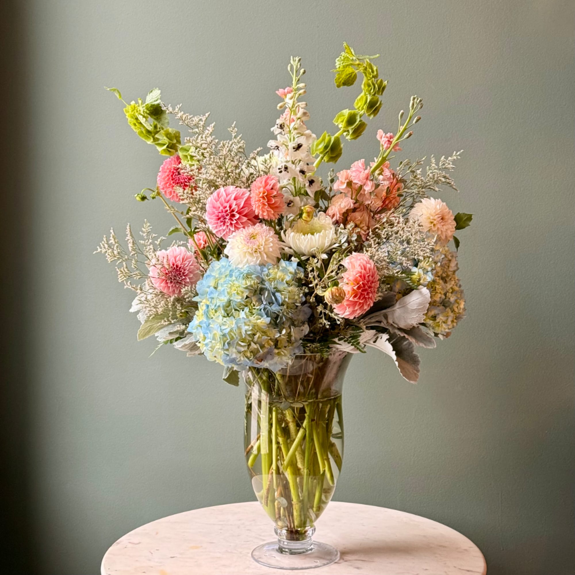 Mixed pastel flower arrangement in a clear glass vase
