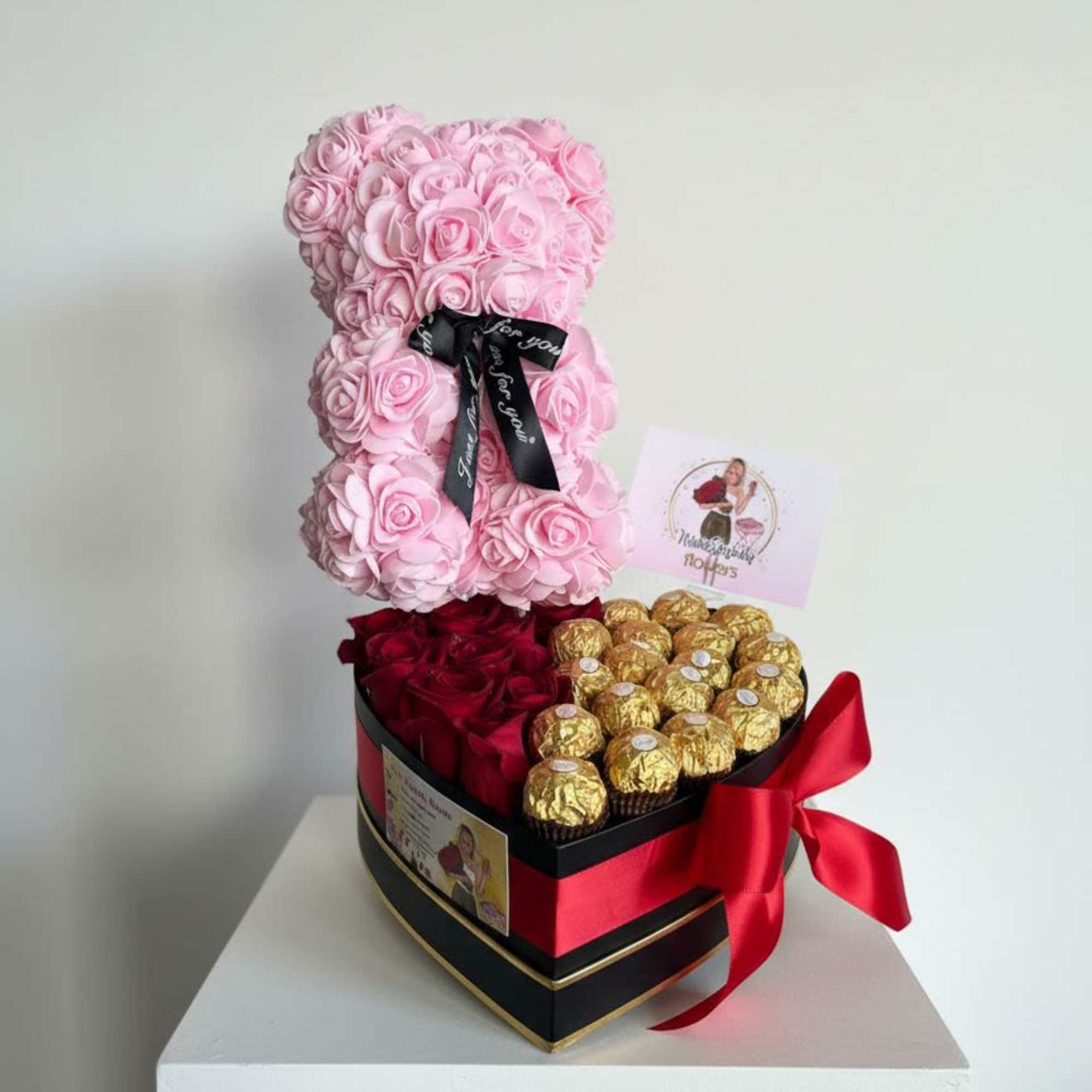 Pink rose teddy bear with red roses and gold chocolates in a heart-shaped box