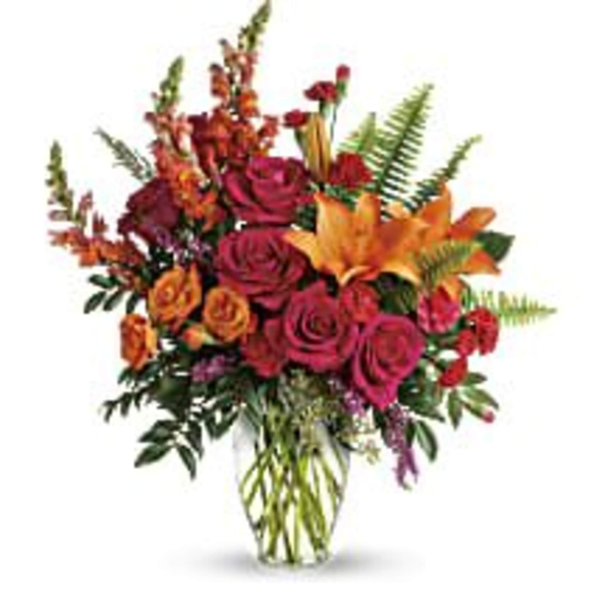 Bouquet of red and orange roses in a clear glass vase