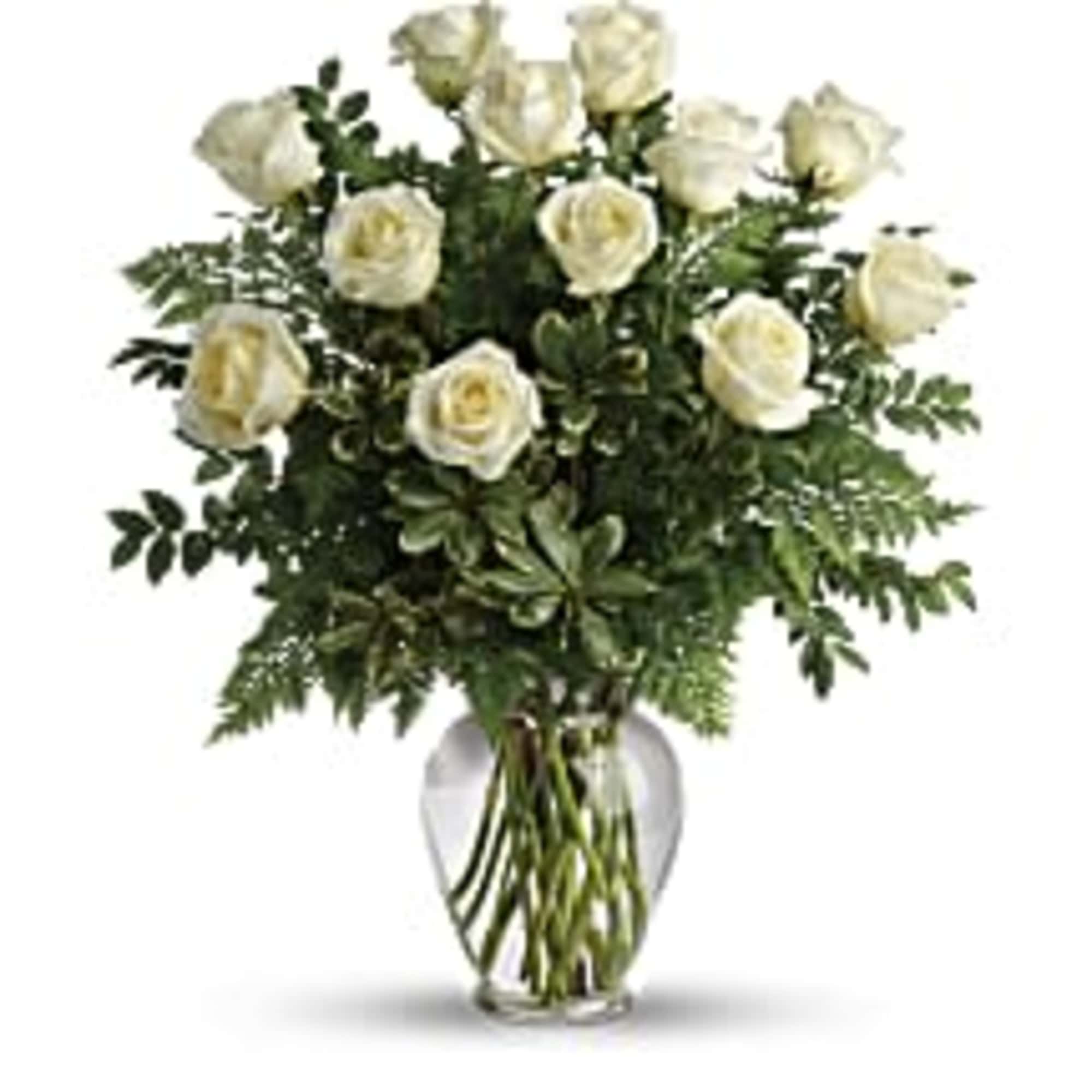 White roses arranged in a clear glass vase
