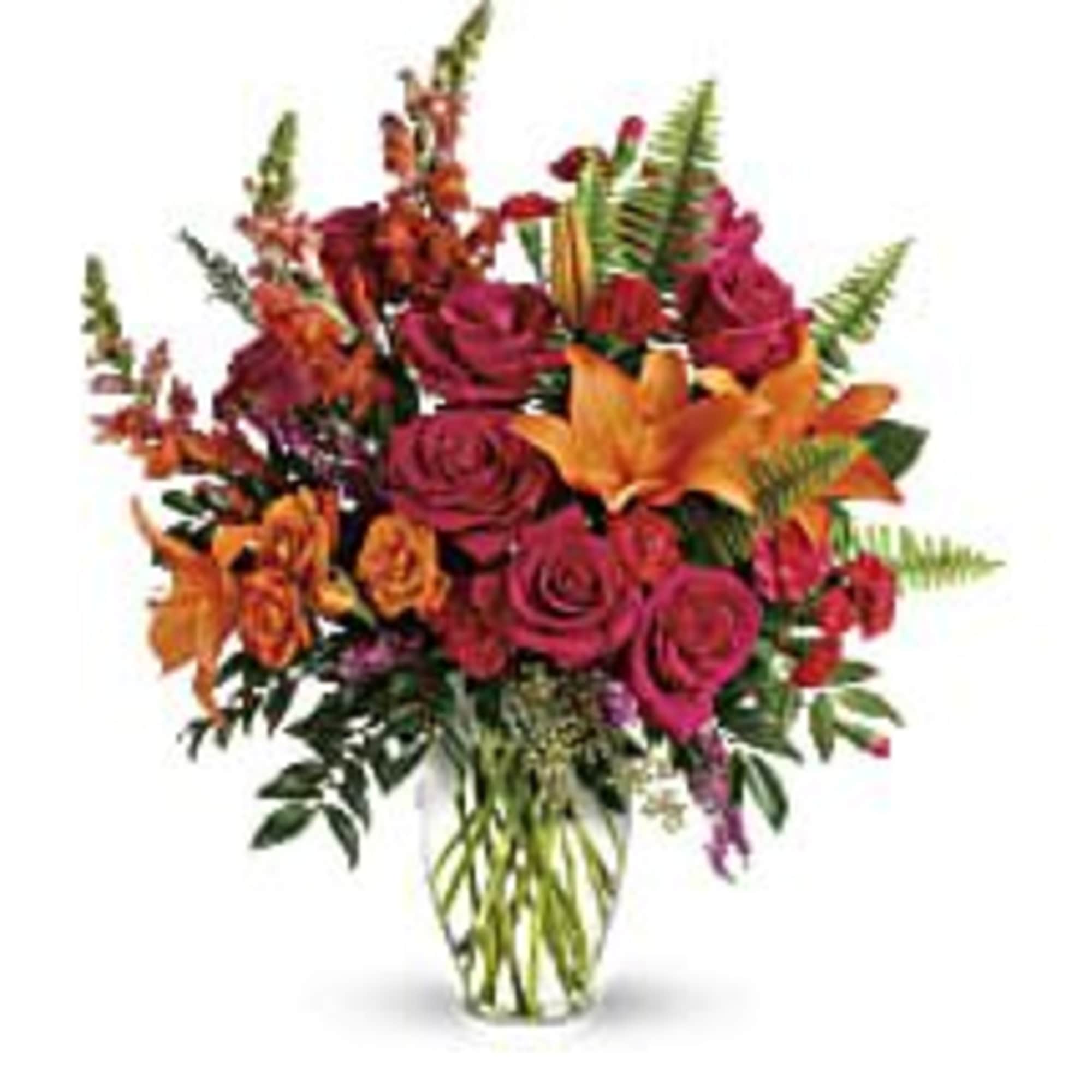 Bouquet of red roses and orange lilies in a glass vase