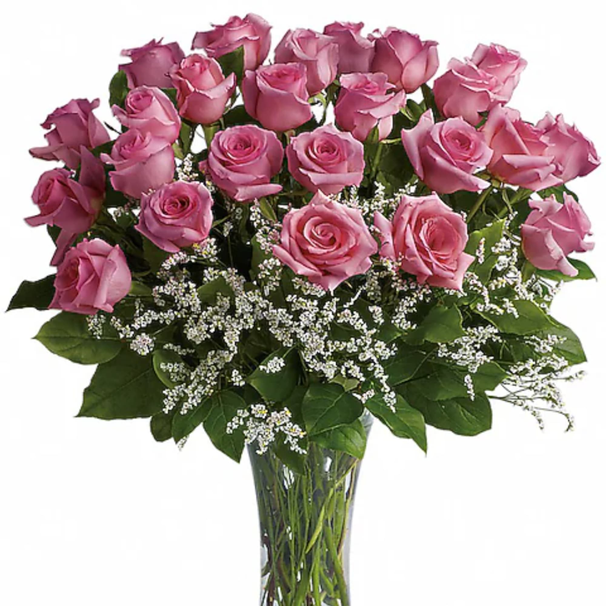 Pink roses arranged in a clear glass vase with white filler flowers