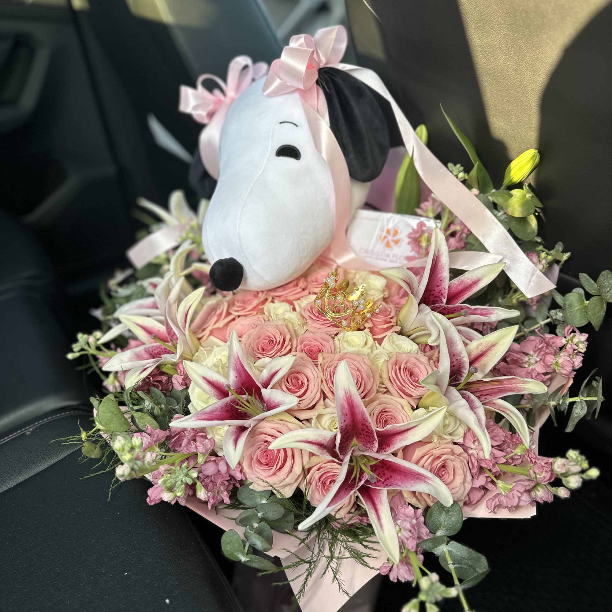 Pink rose bouquet with stargazer lilies and a Snoopy plush topper