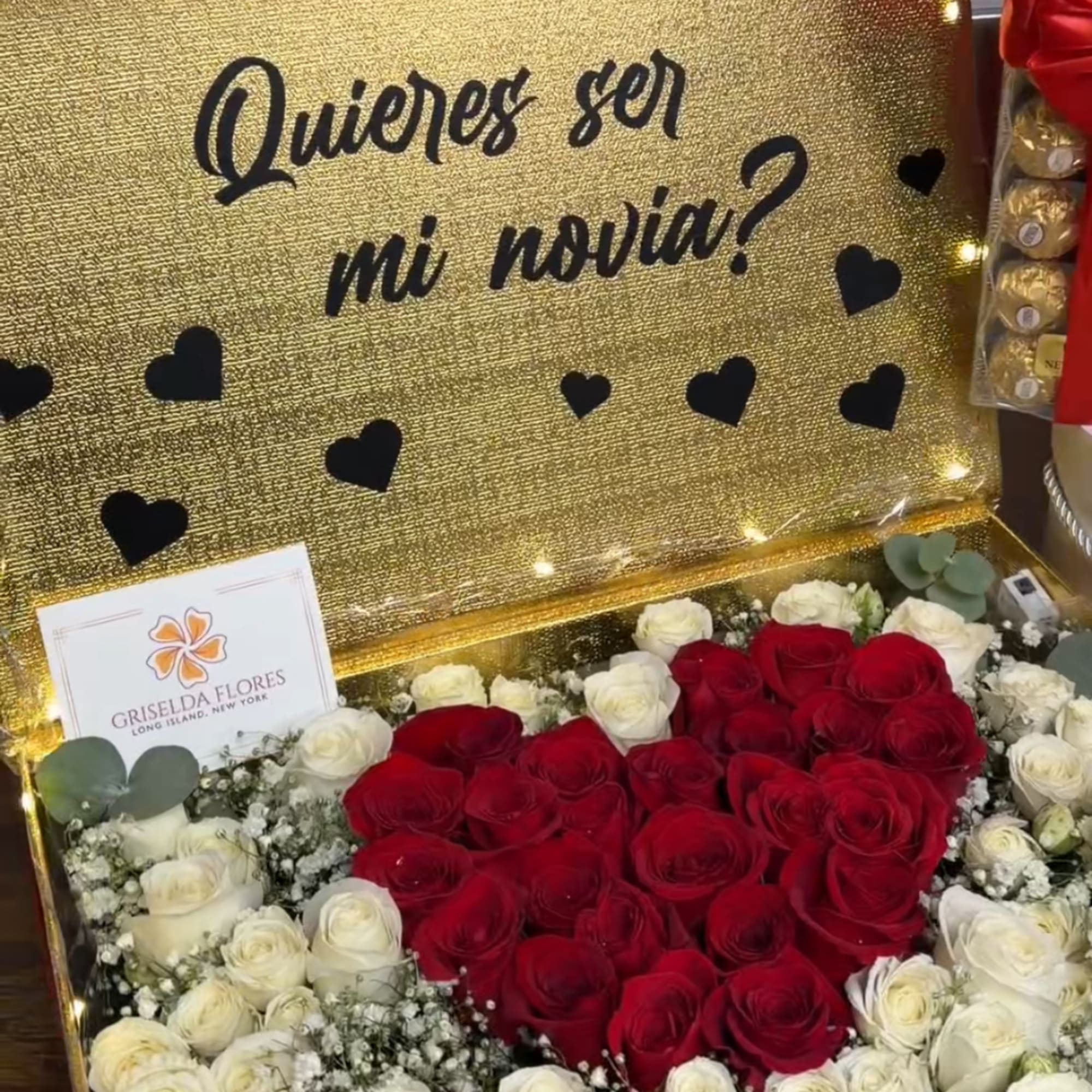 Heart-shaped box of red and white roses with black heart decorations