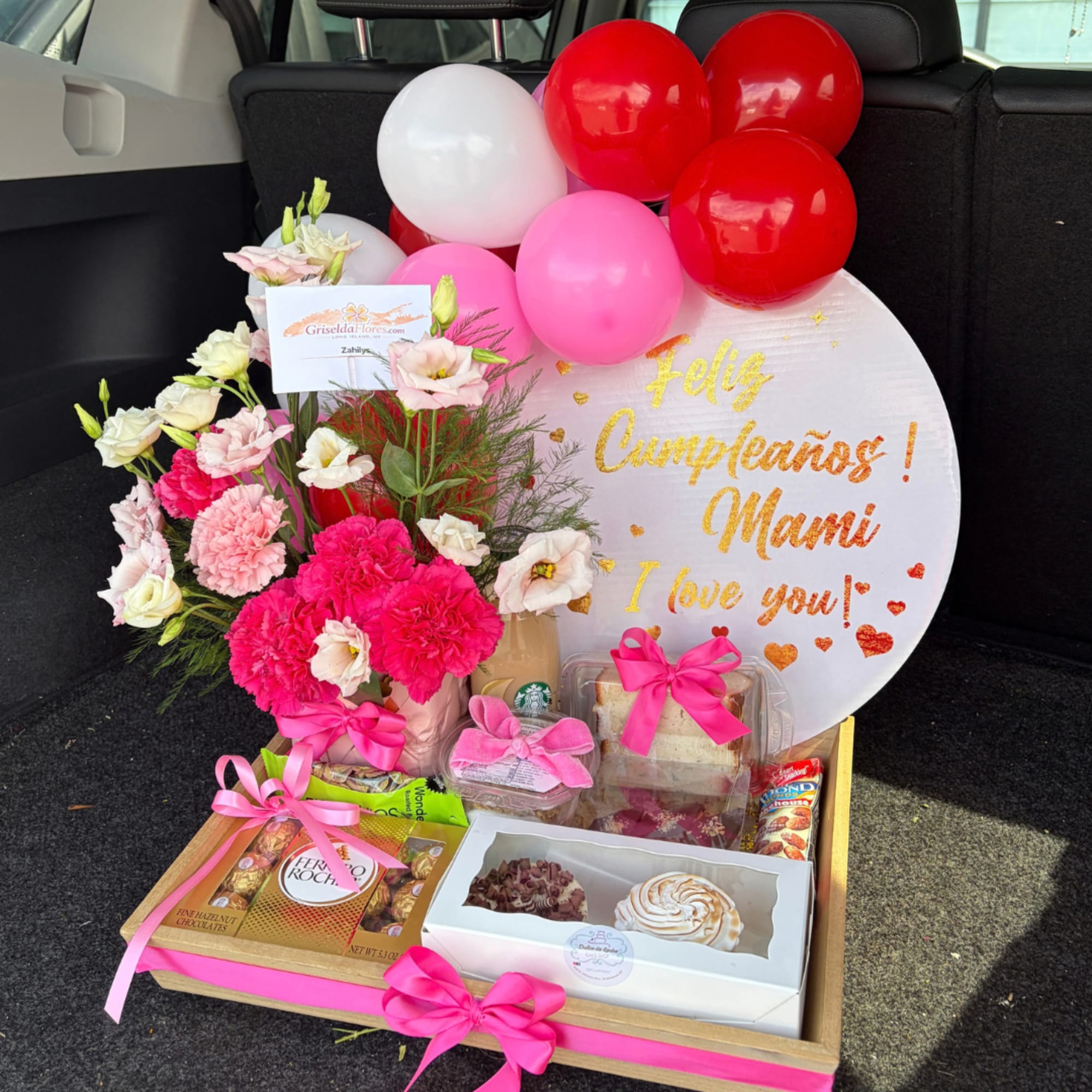 Birthday gift tray with flowers, balloons, chocolates, and a message board