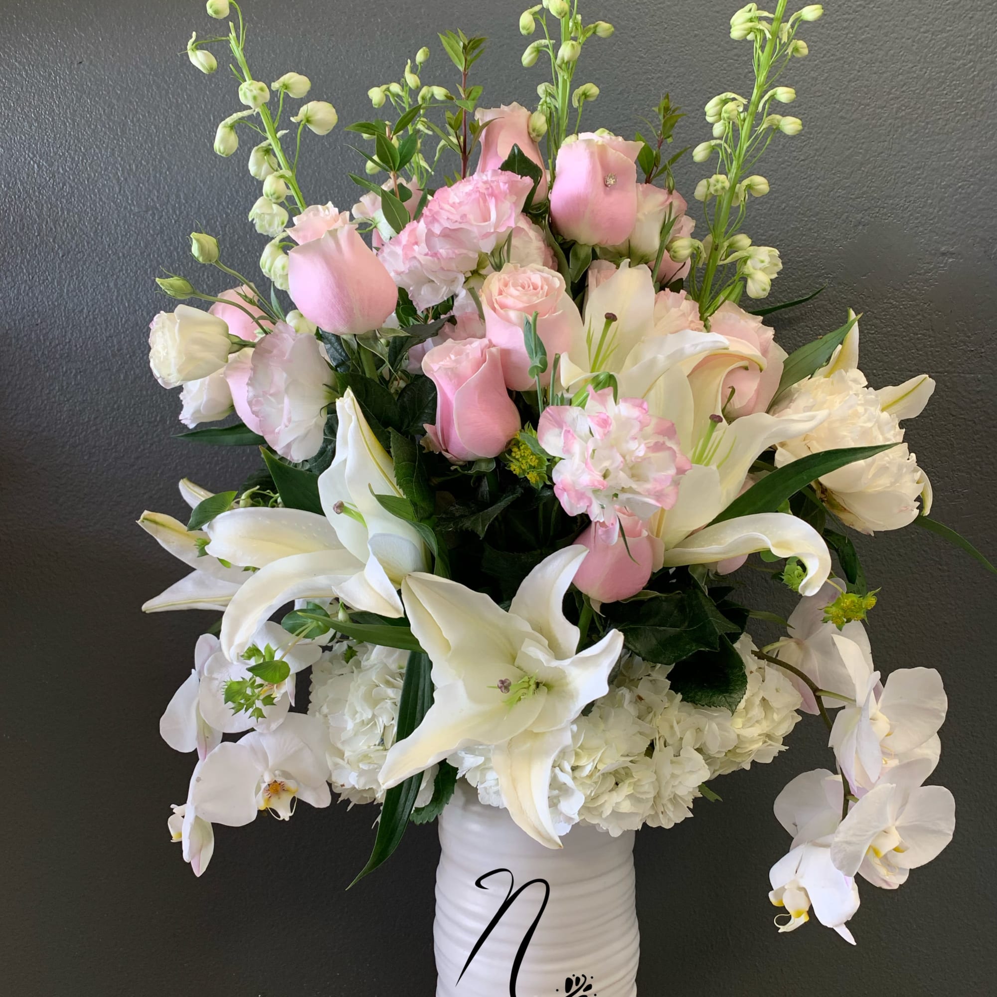 Pink and white floral arrangement in a white vase