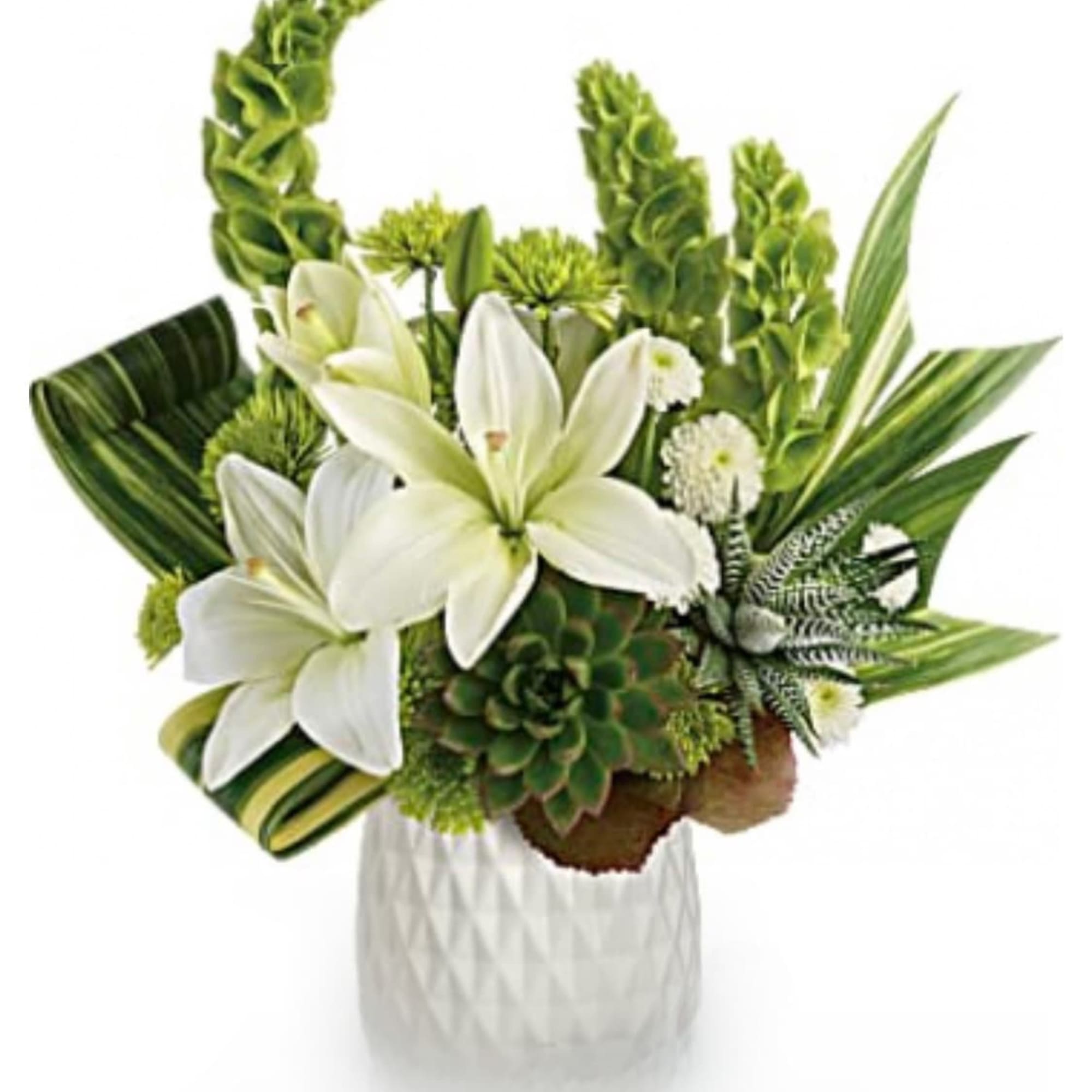 White lilies and green tropical flowers in a white vase