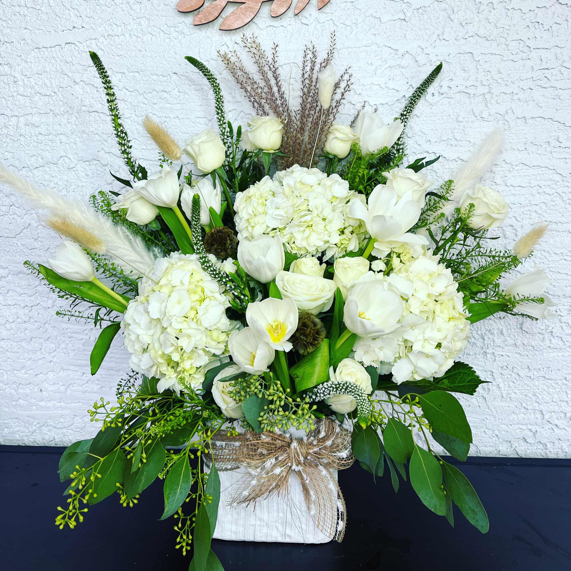 White floral arrangement with tulips and hydrangeas in a wrapped container, photo 2 of 2