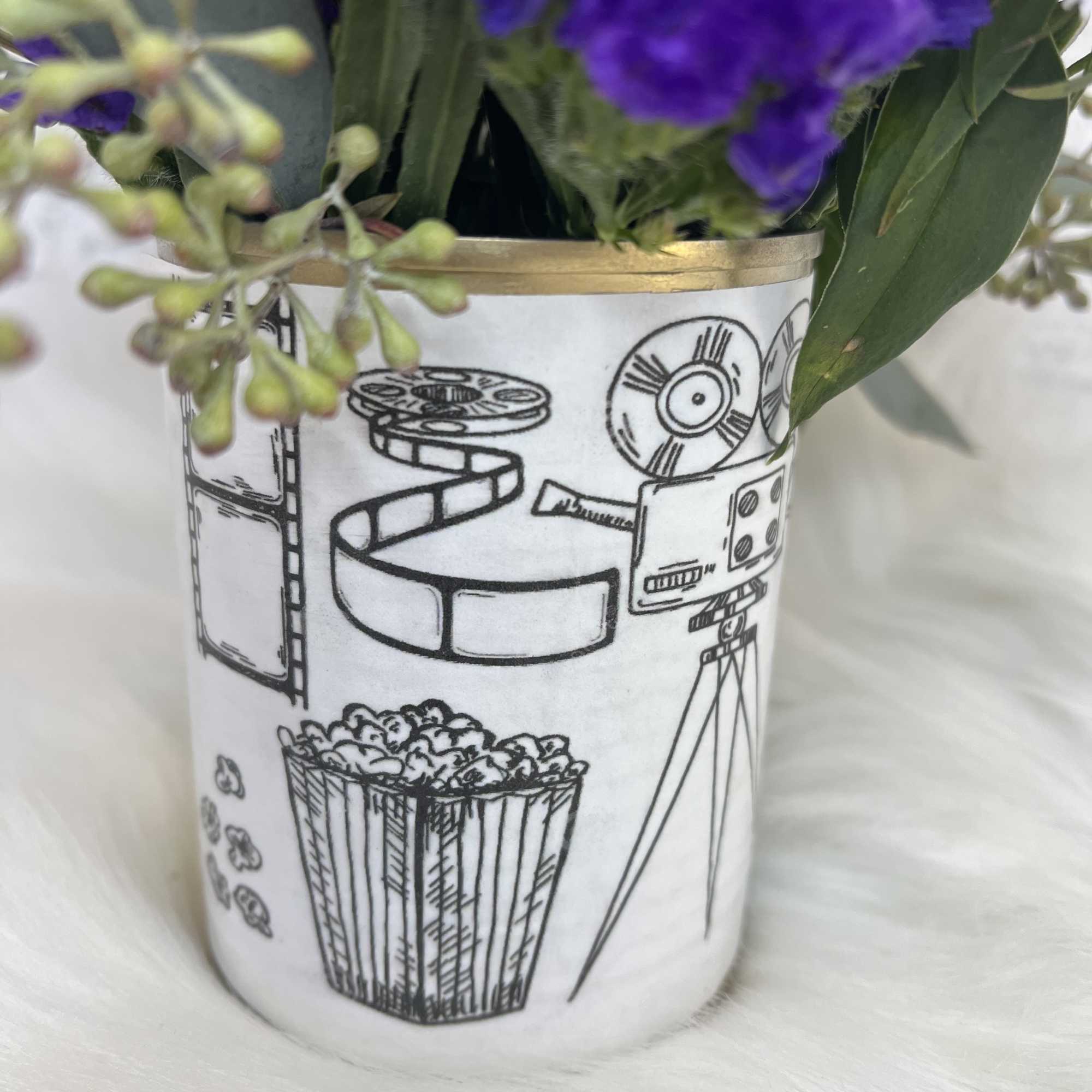 Purple flowers in a white illustrated container