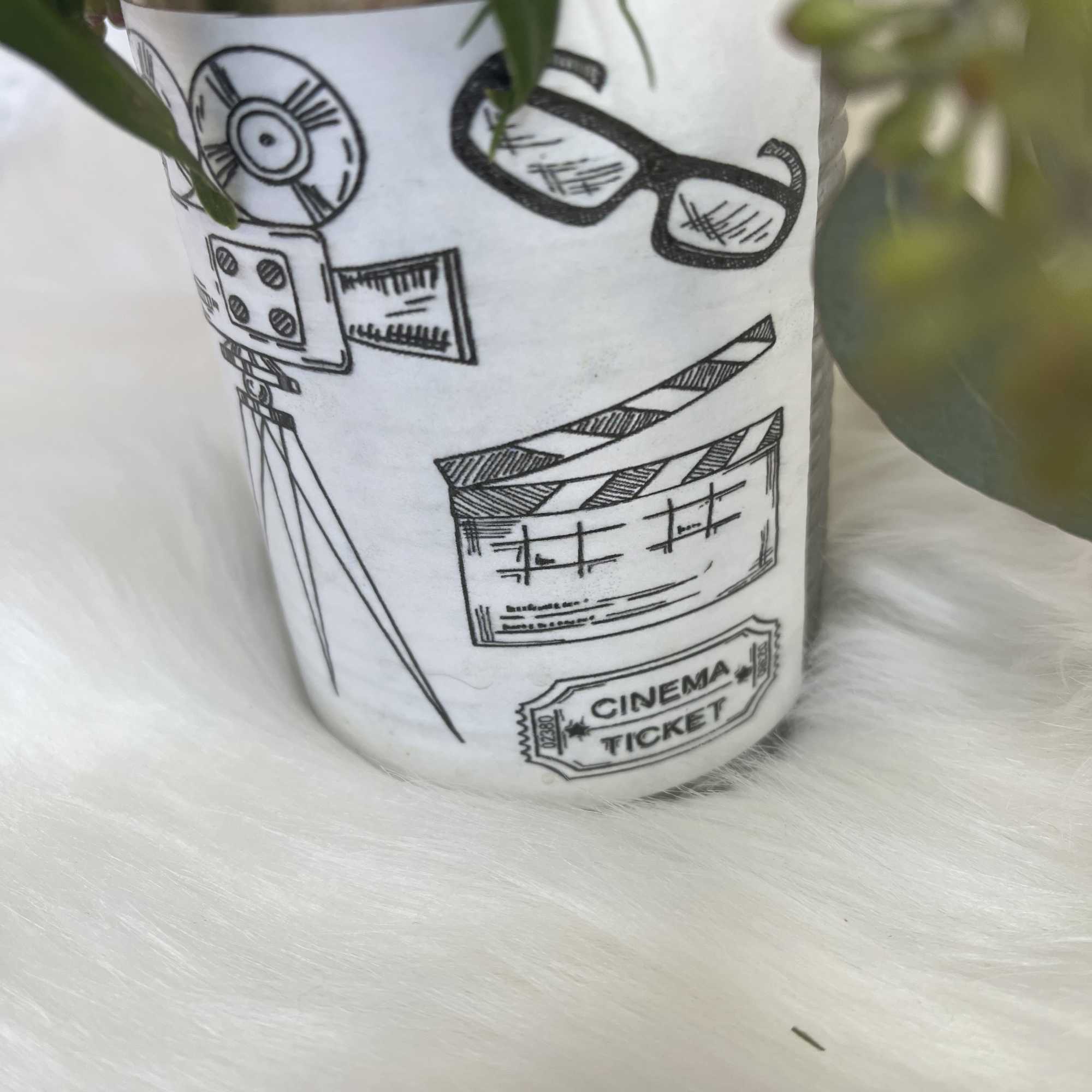 Potted plant in a white cinema-themed container
