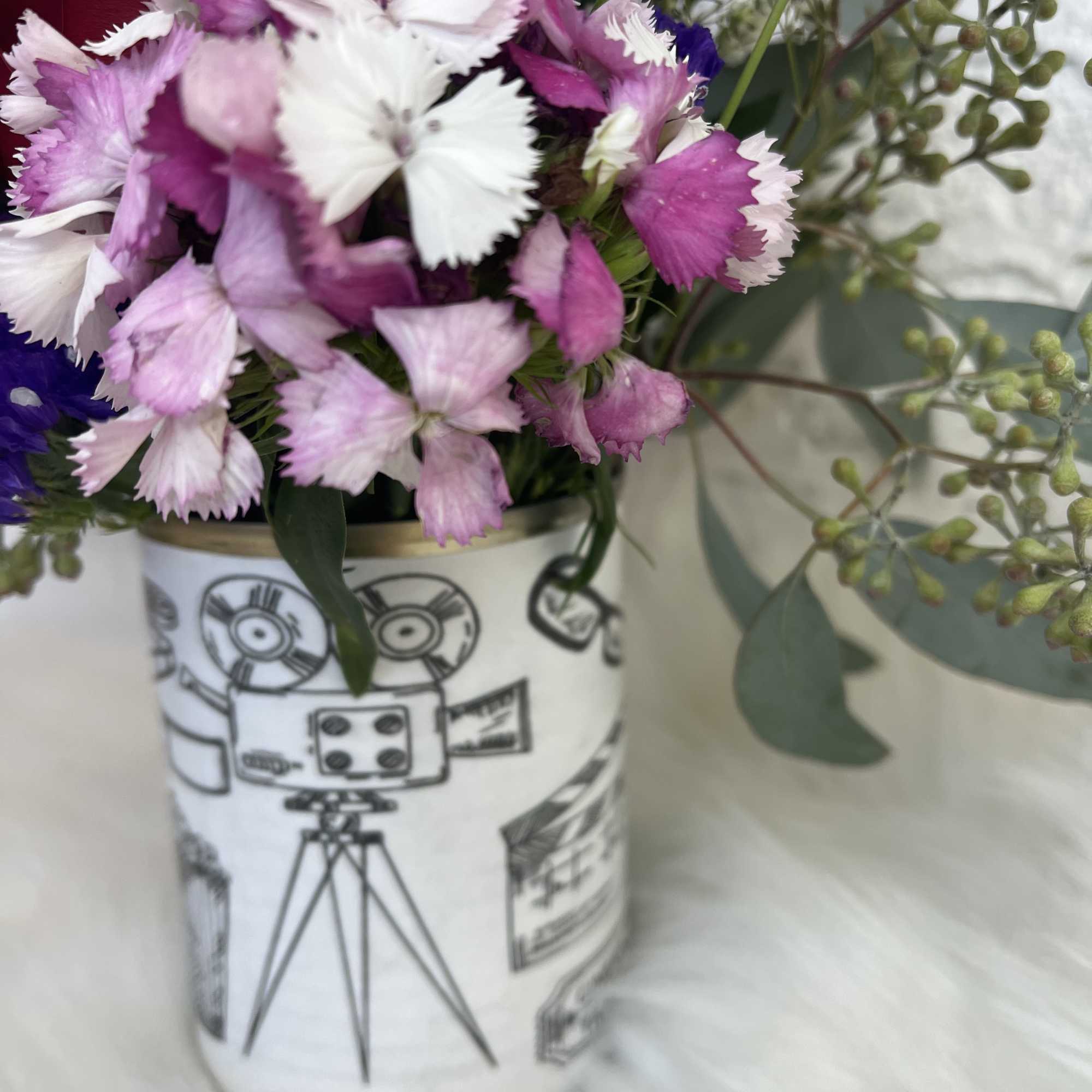 Pink and white carnations in a patterned ceramic vase