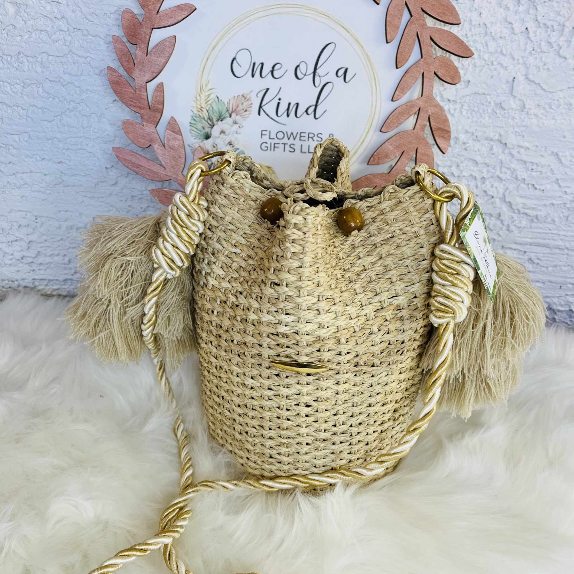 Woven straw basket bag with braided gold-and-white straps