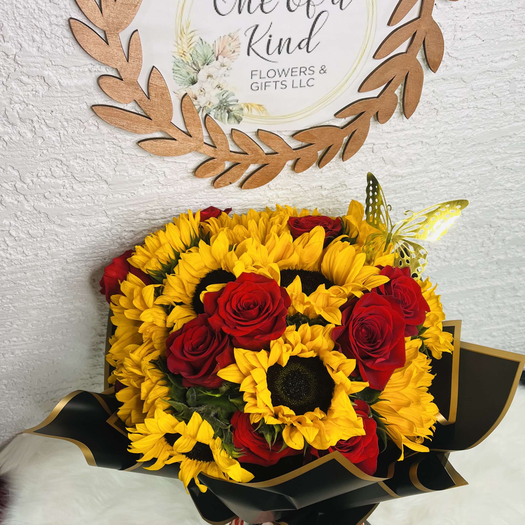 Bouquet of yellow sunflowers and red roses wrapped in black paper, photo 2 of 3