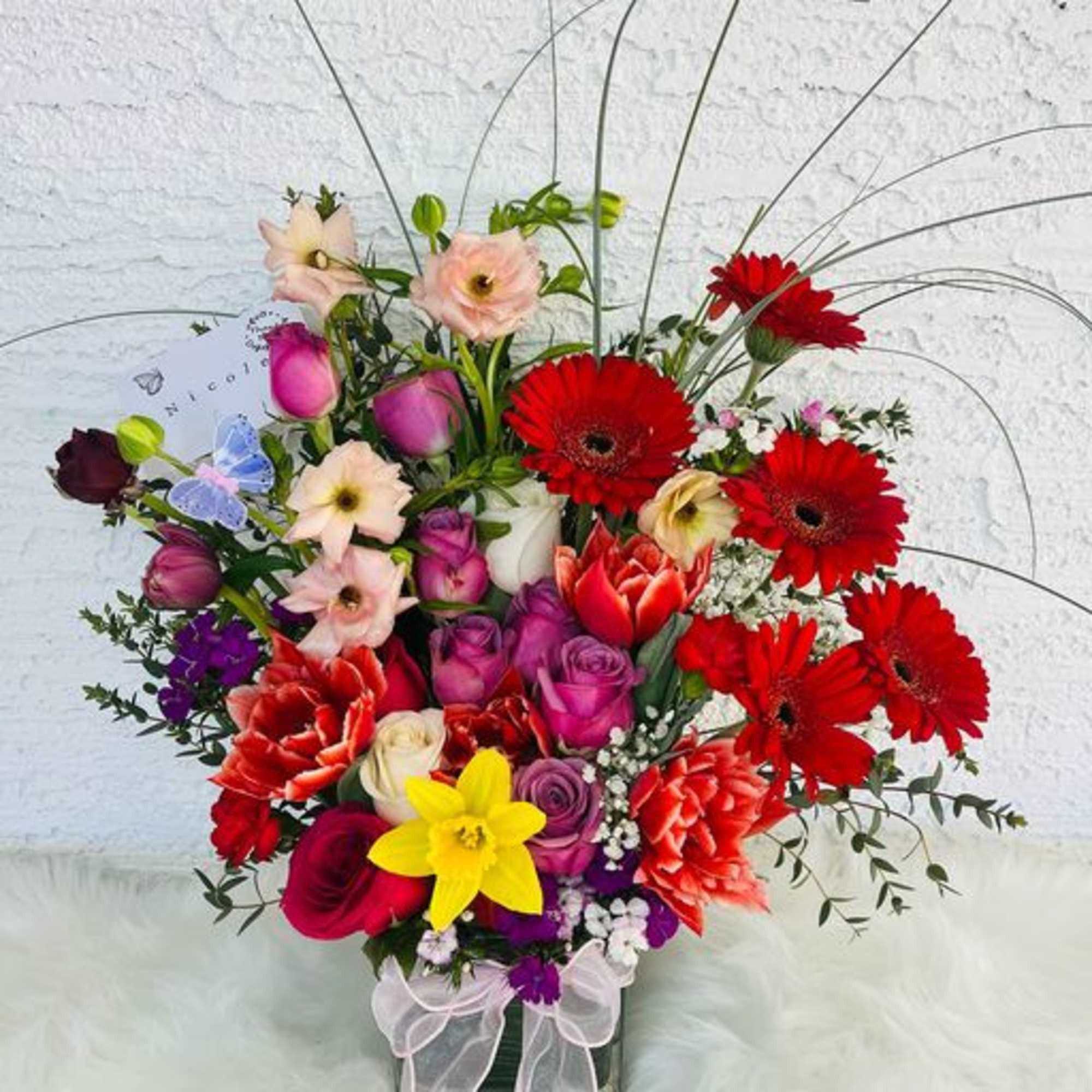 Colorful mixed bouquet with gerbera daisies and roses in a vase