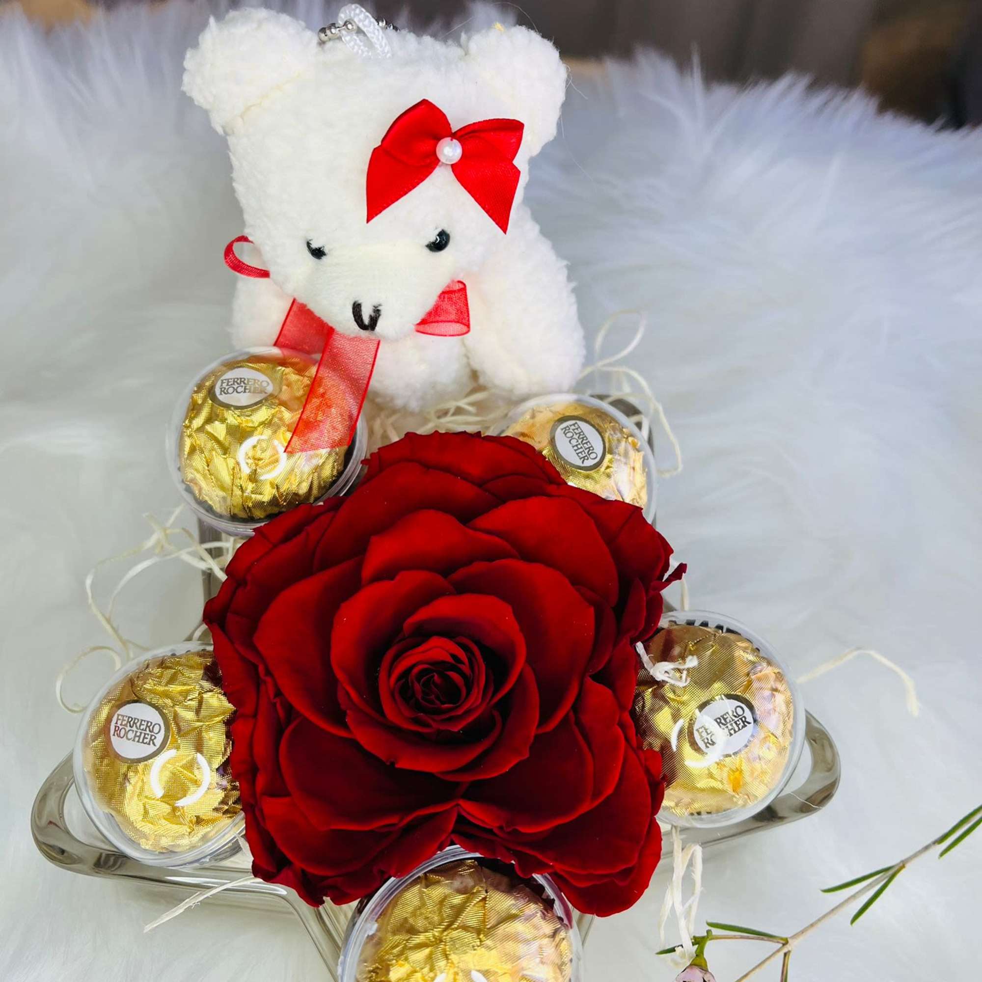 Red rose arrangement with a teddy bear and Ferrero Rocher chocolates