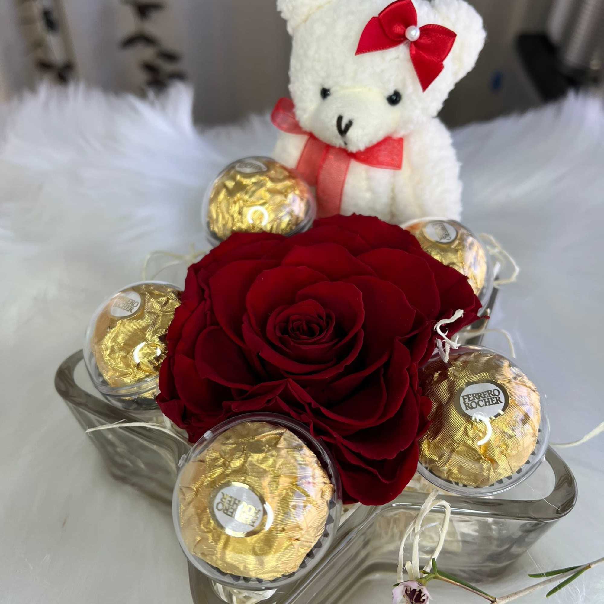 Red rose arrangement with Ferrero Rocher chocolates and a small teddy bear
