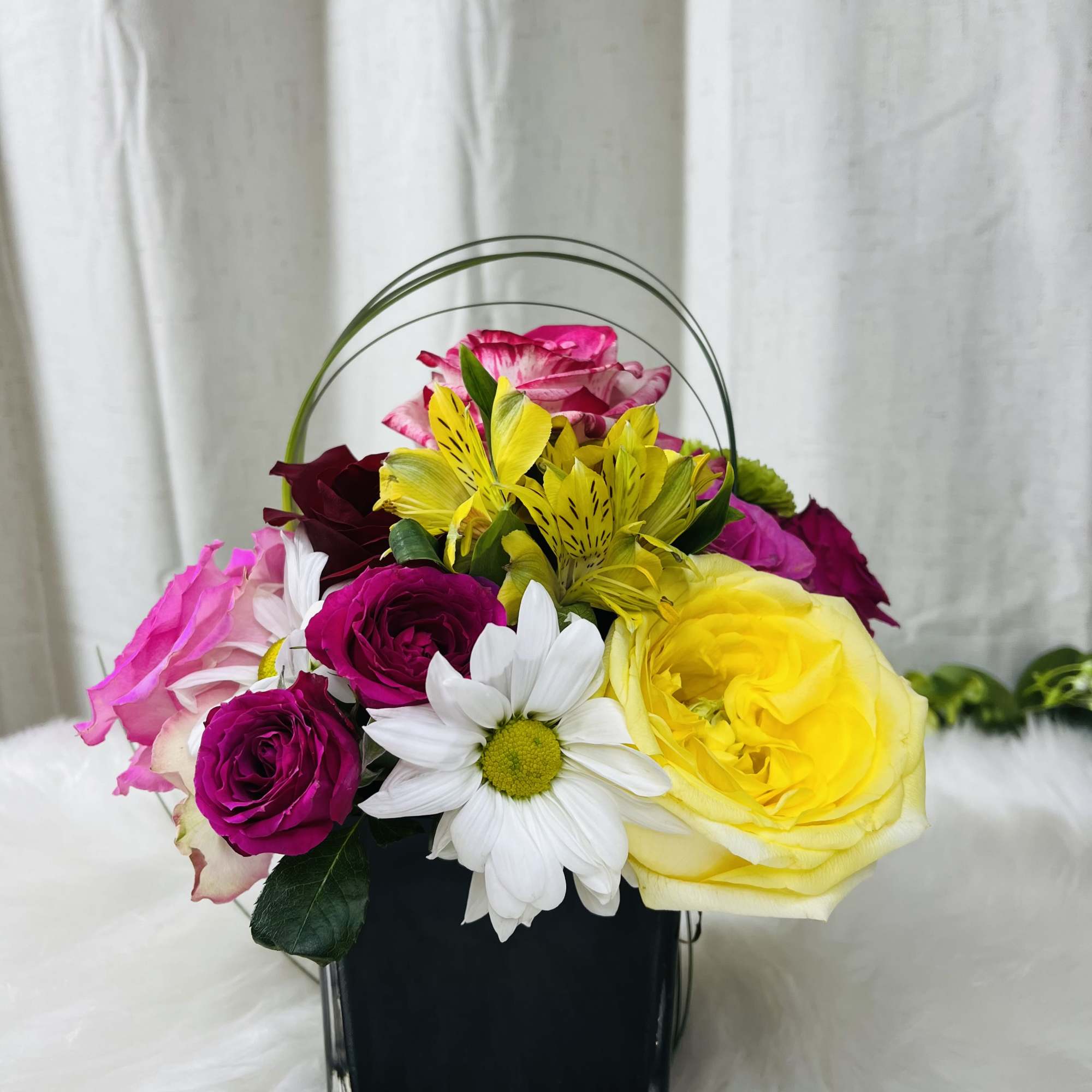 Colorful flower basket with roses, daisies, and yellow alstroemeria