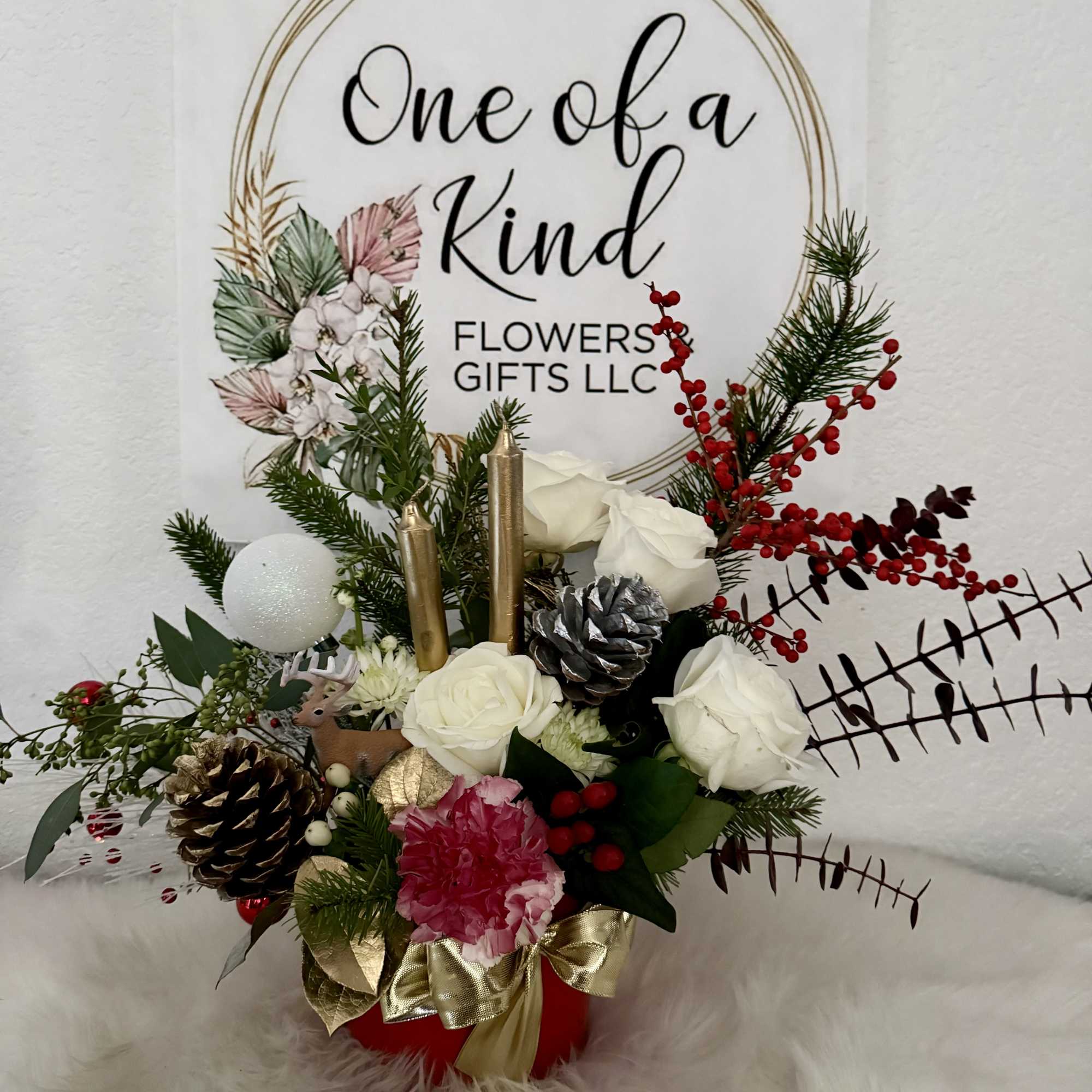 Holiday floral arrangement with white roses, pinecones, and red berries in a red container, photo 3 of 4