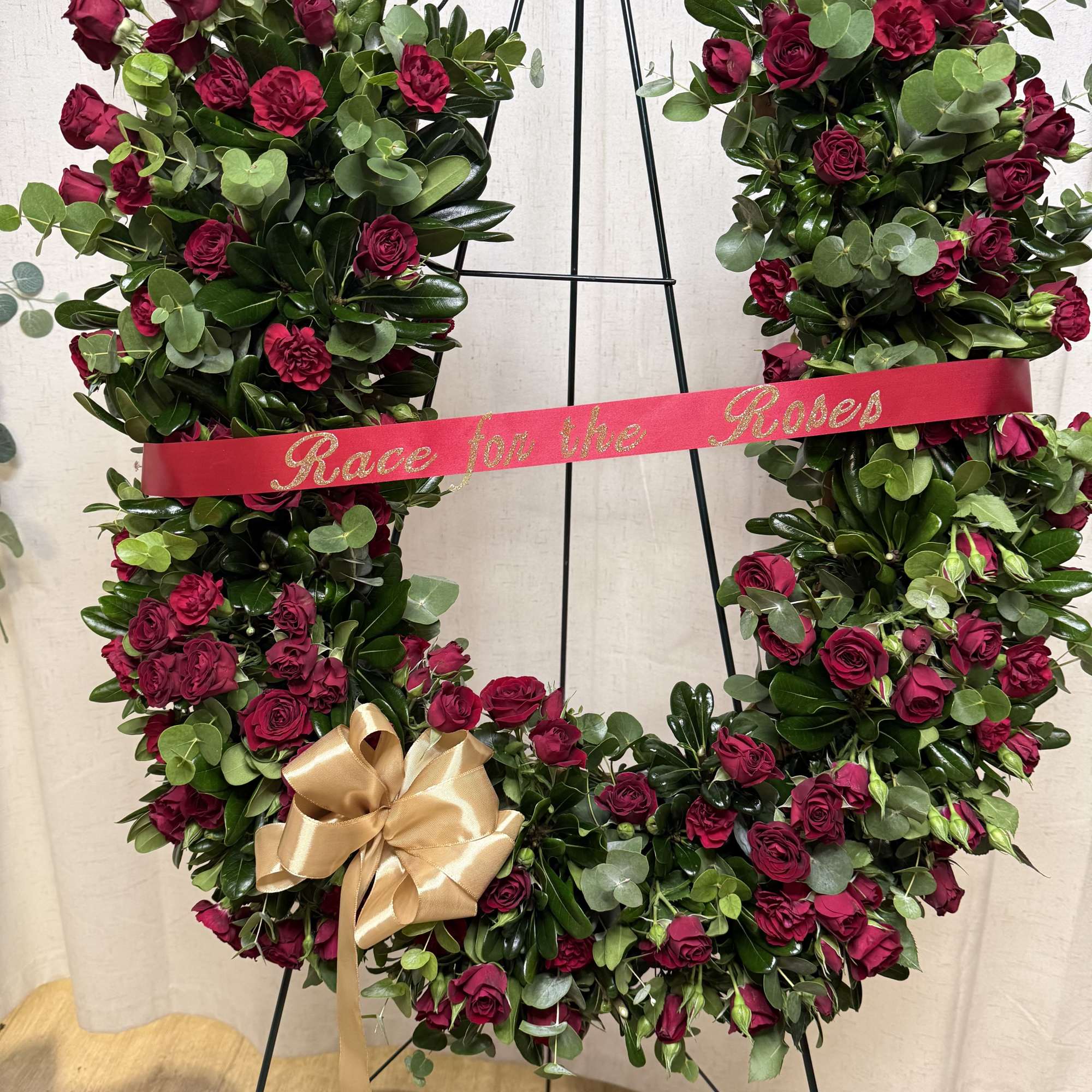 A beautiful and meaningful horseshoe-shaped floral tribute, designed to honor a loved, photo 2 of 3