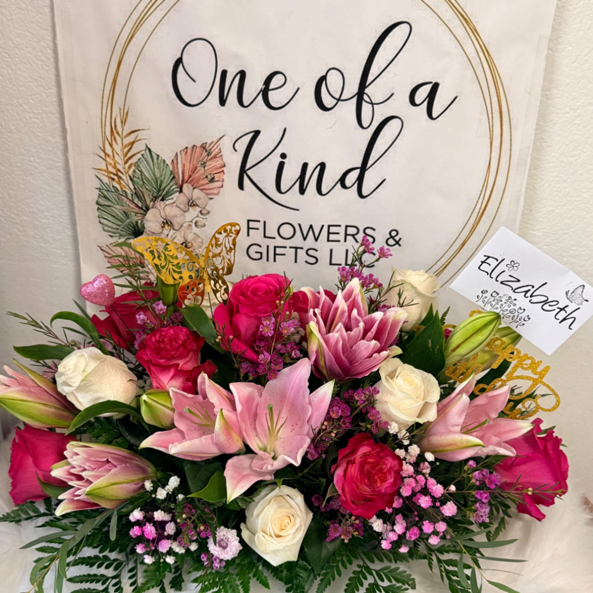 Pink and white rose bouquet with lilies and a gift card