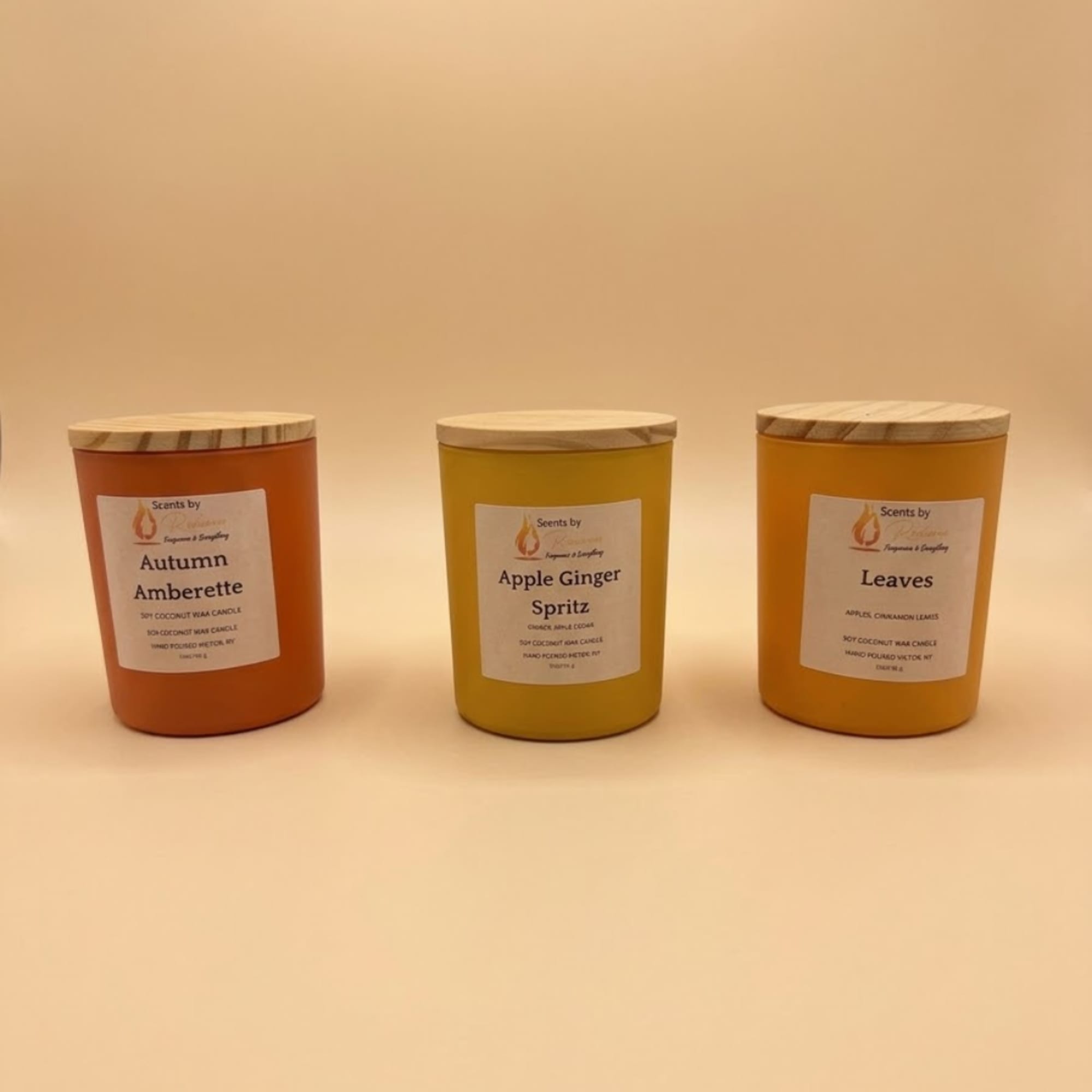 Three scented candles in glass jars with wooden lids