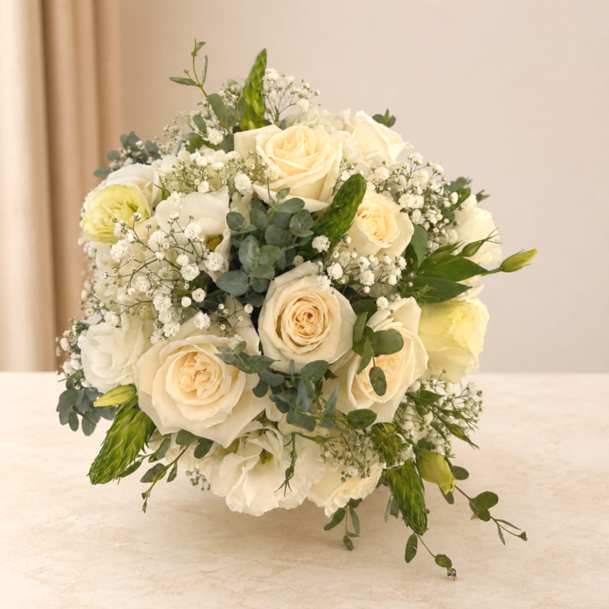 Cream rose bridal bouquet with white filler flowers and greenery