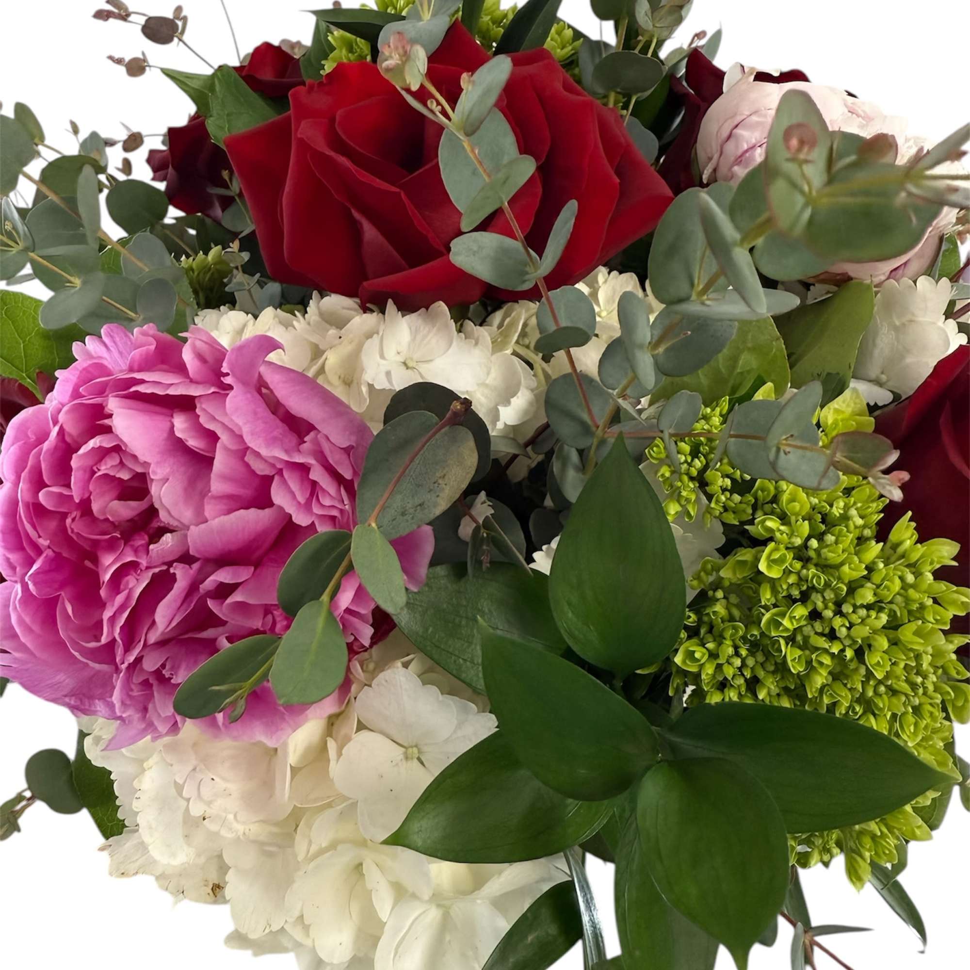 Bouquet of red roses, pink peonies, and white hydrangeas with eucalyptus