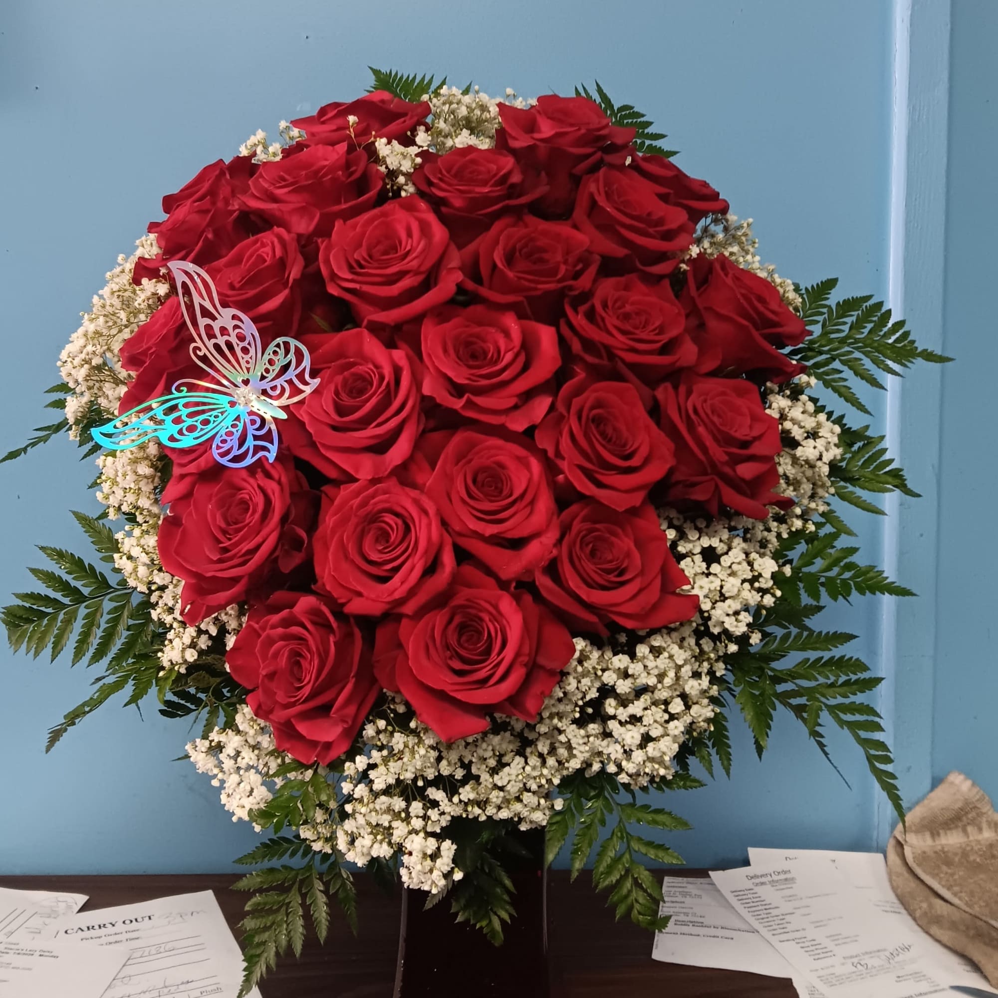 premium red roses artistically designed in a heart shape in a red