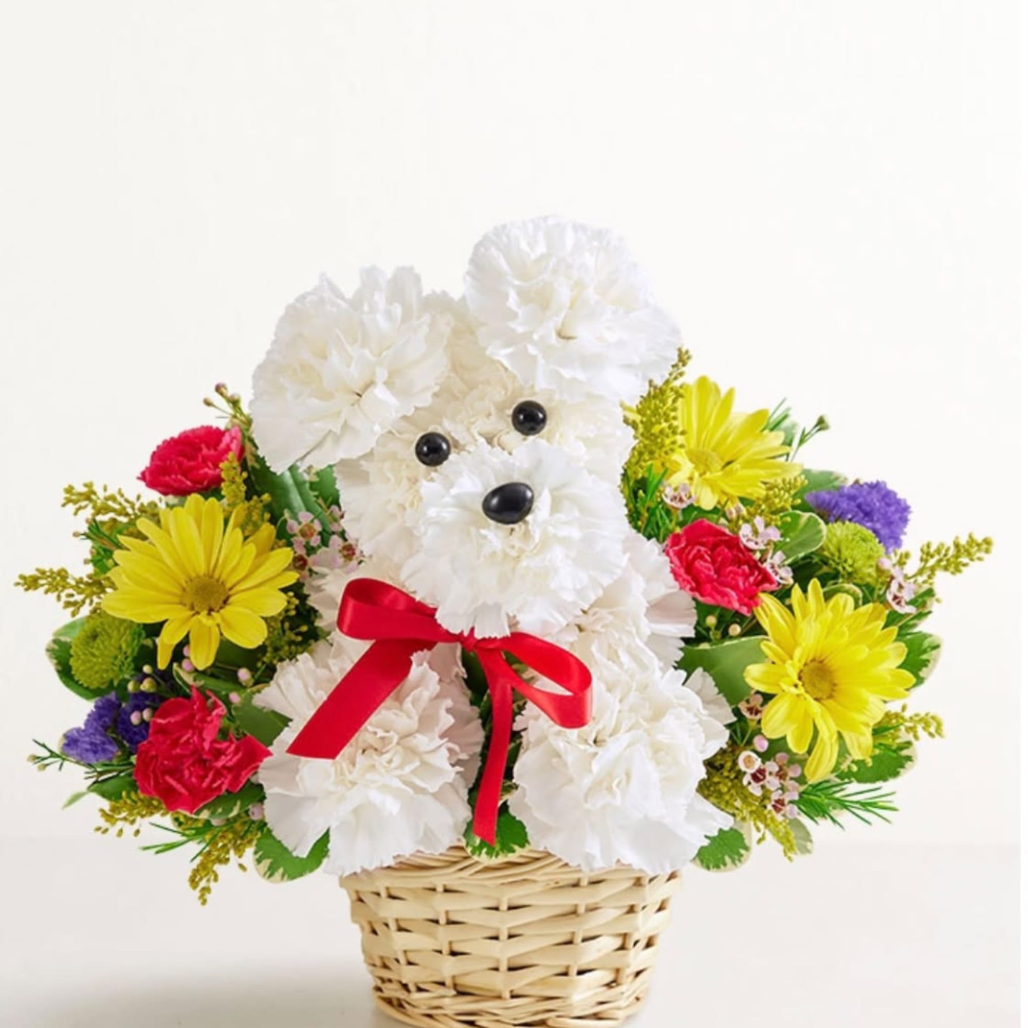 White teddy bear made of flowers in a wicker basket with a red bow