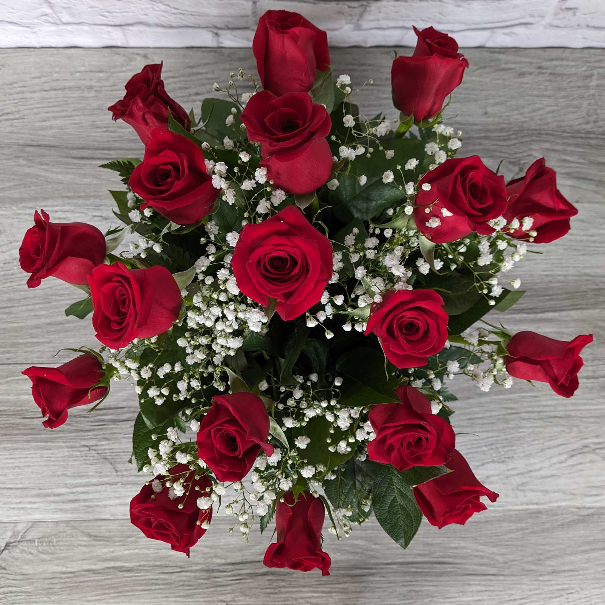 Refined Red Roses uses shorter rose stems in a colored glass vase, photo 2 of 3