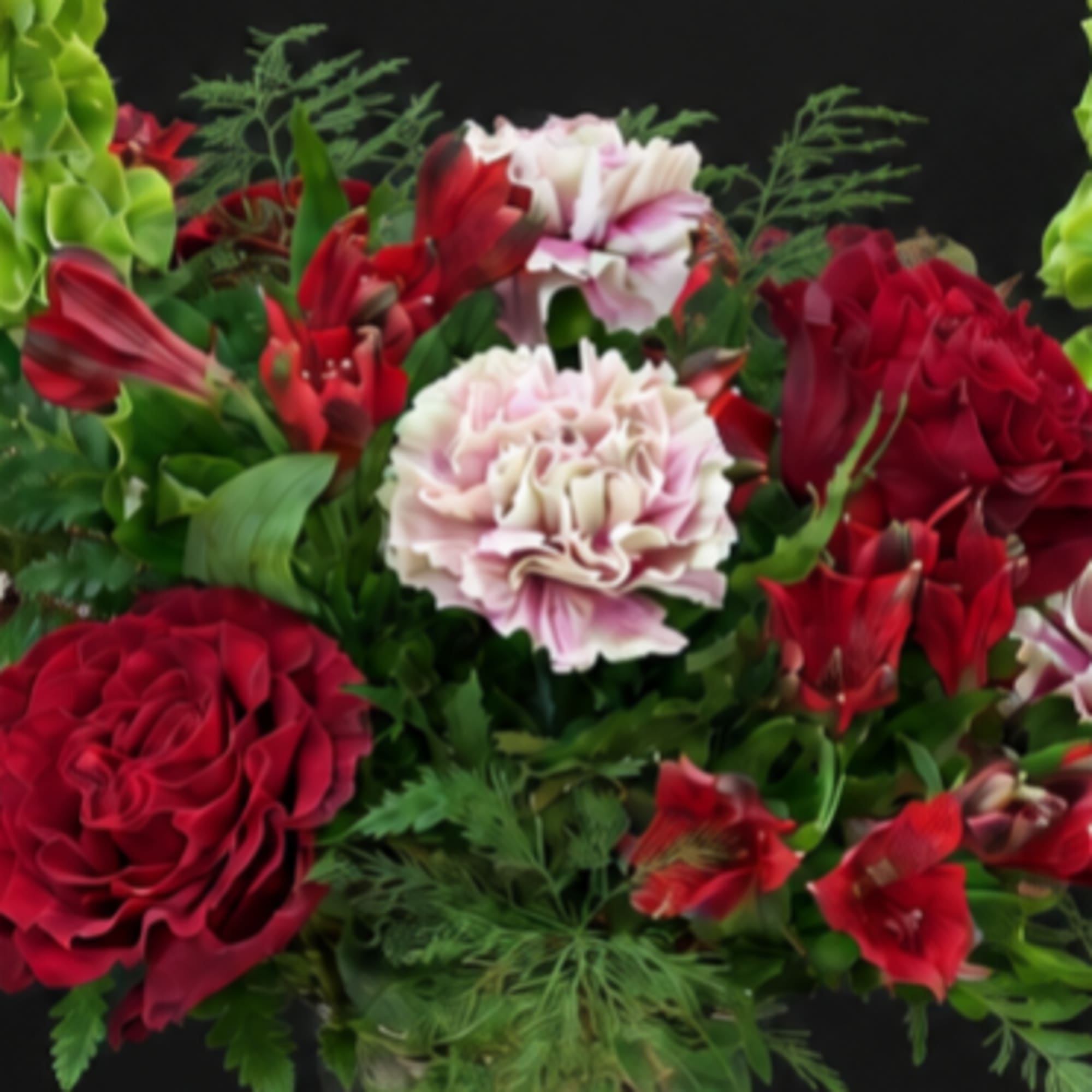 Red and pale pink flowers arranged against a black background