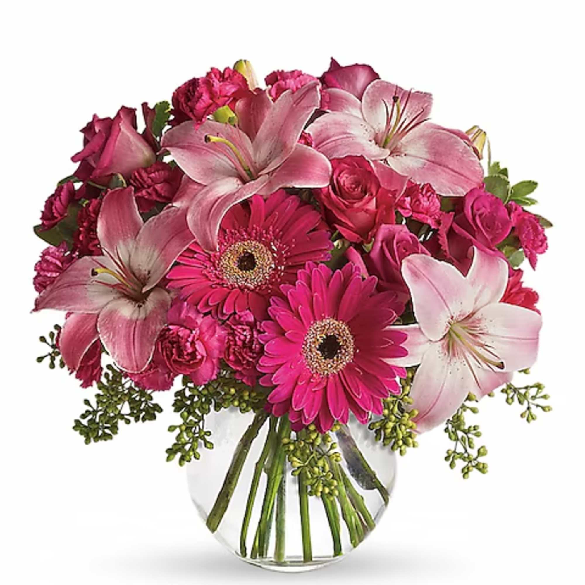 Pink lilies, gerbera daisies, and roses in a clear glass vase