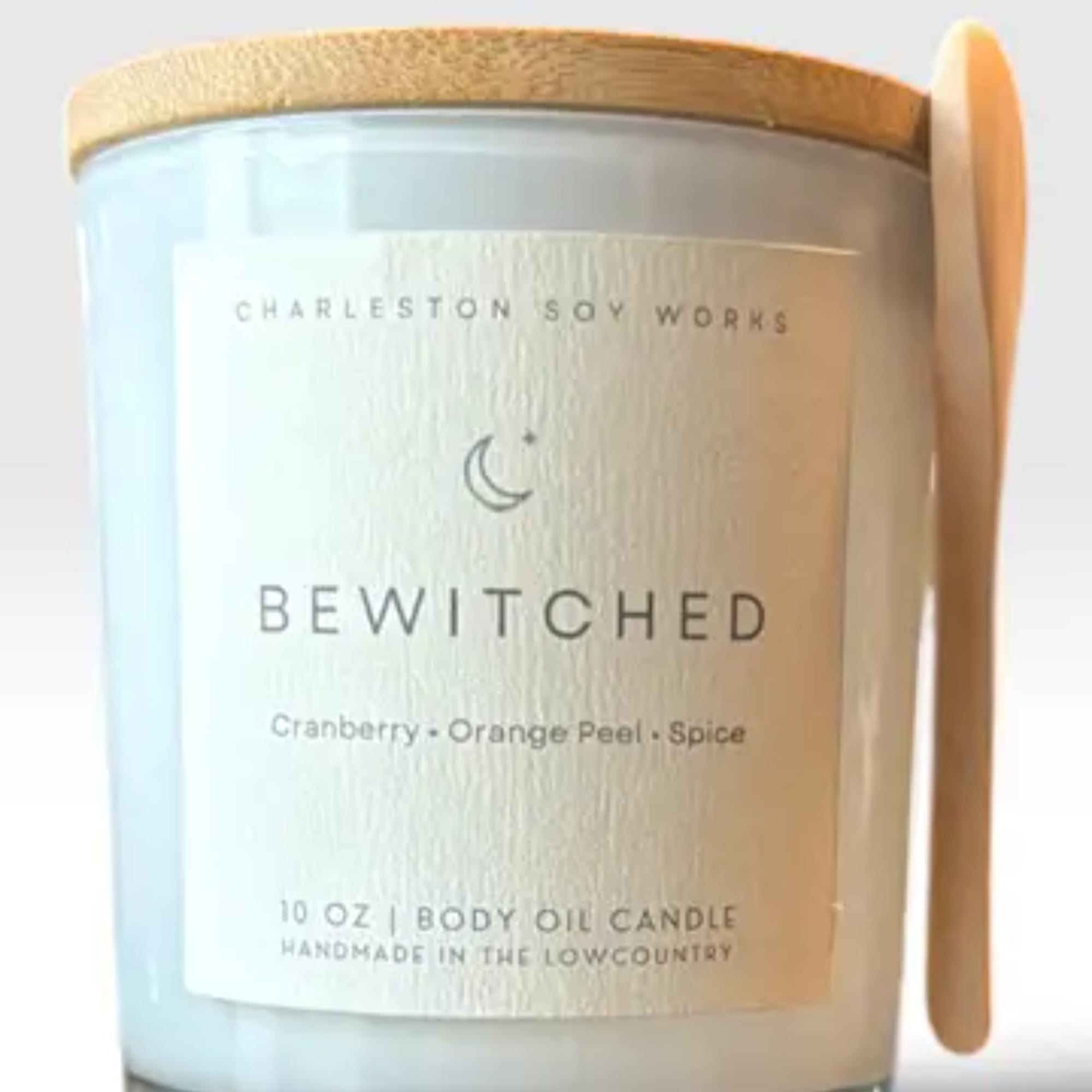 Labeled candle in a glass jar with a wooden lid and spoon, photo 2 of 3