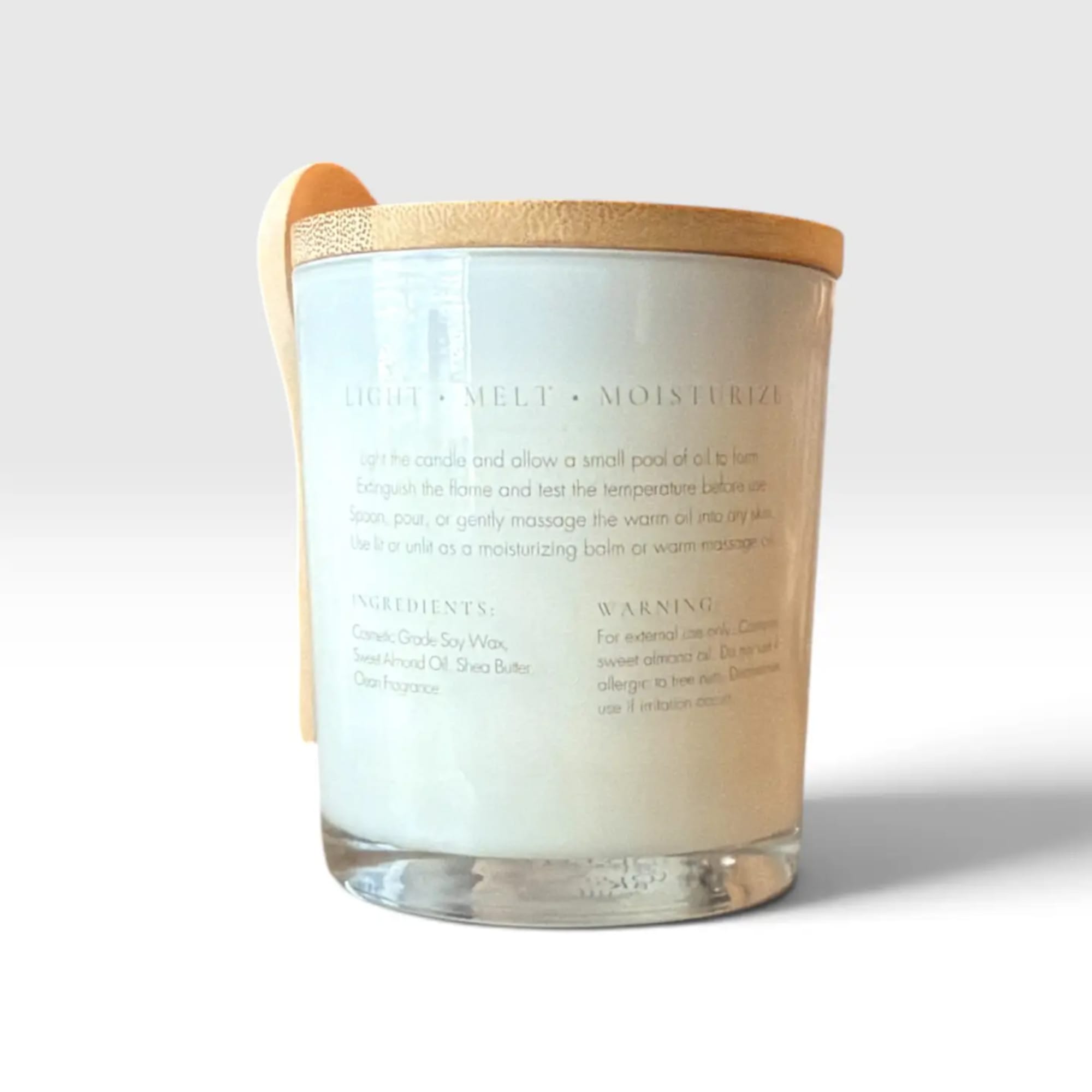 A white candle in a clear glass jar with a wooden lid